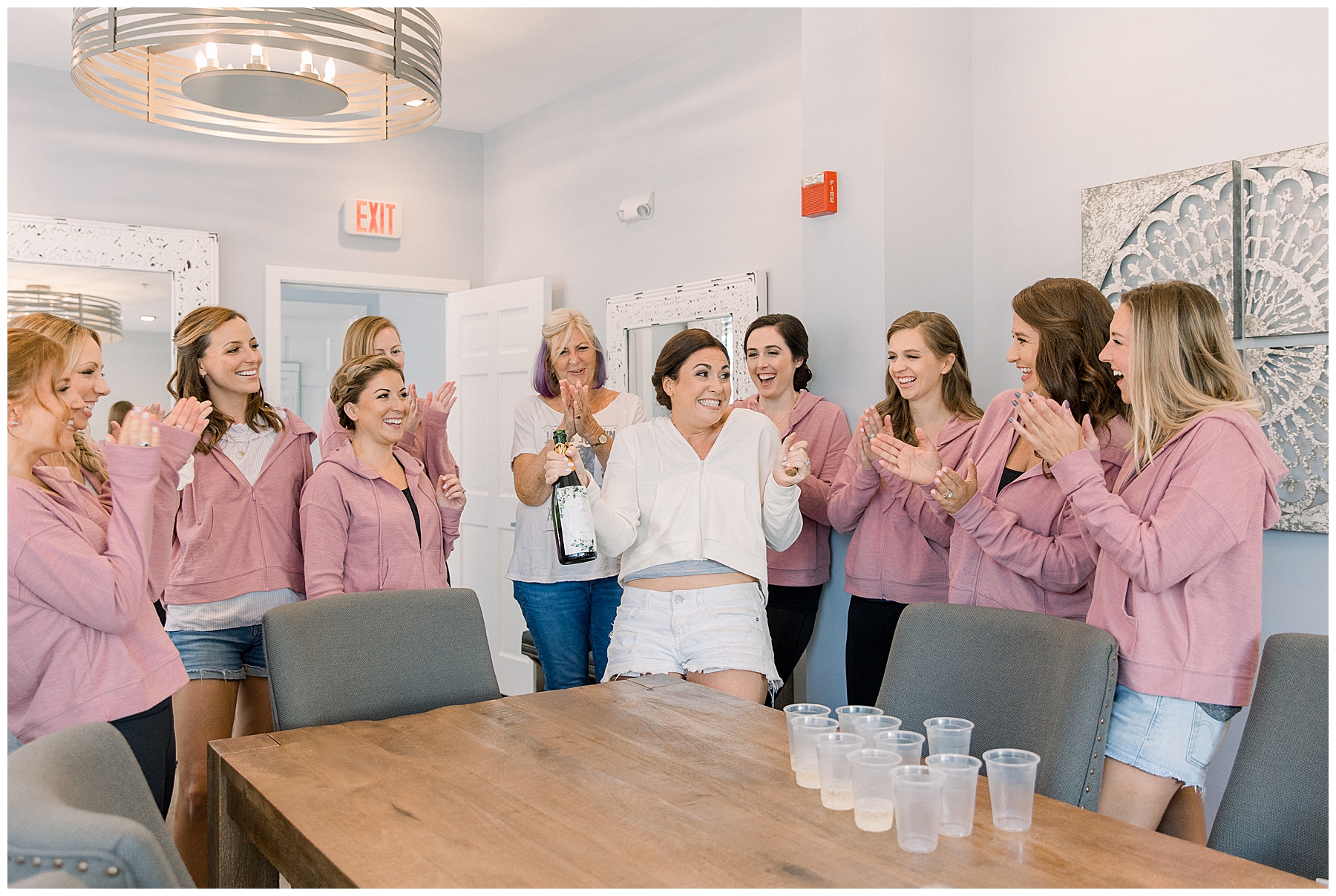 Bridesmaids and bride celebrate wedding day with champagne