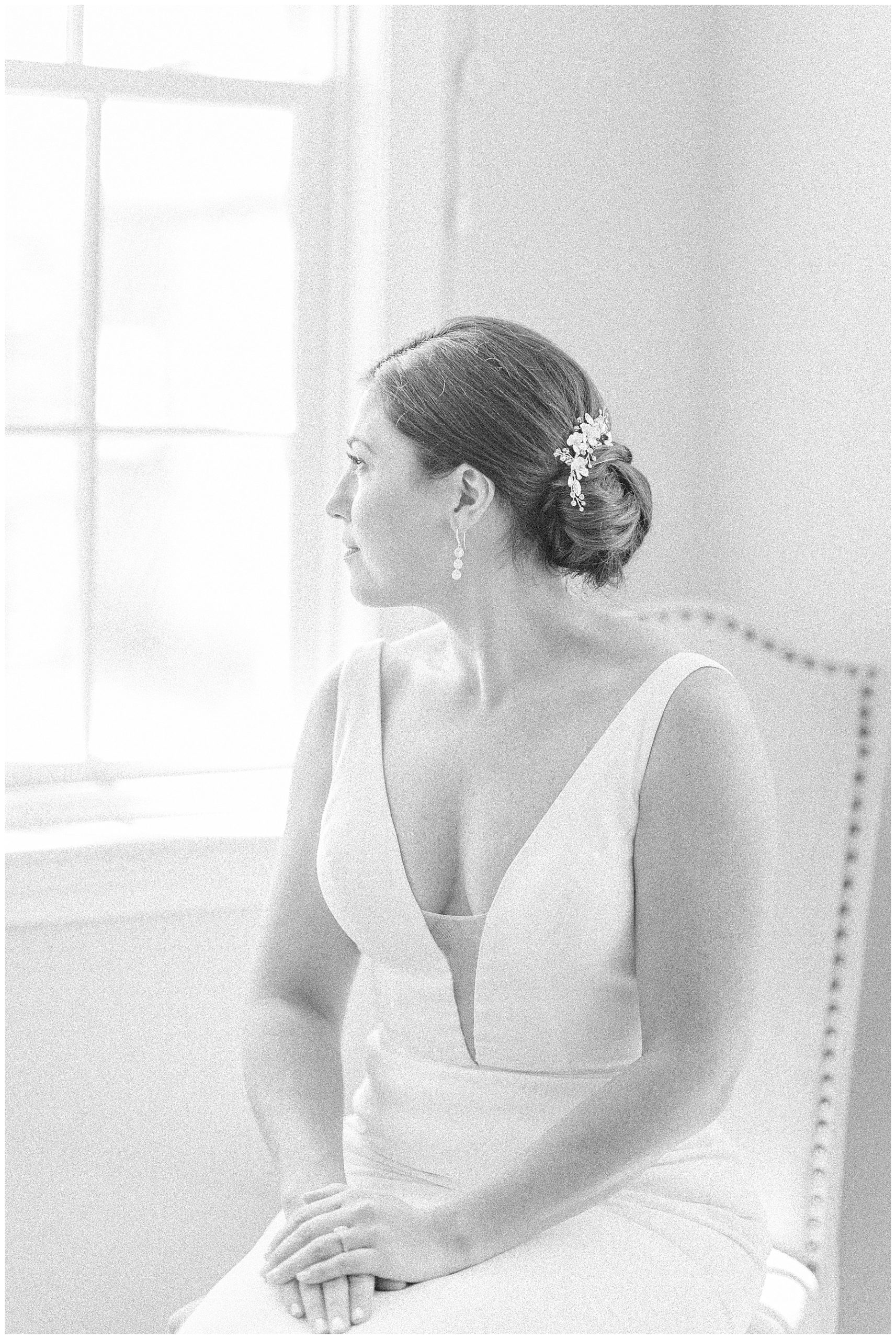 bride looks out of window before wedding ceremony