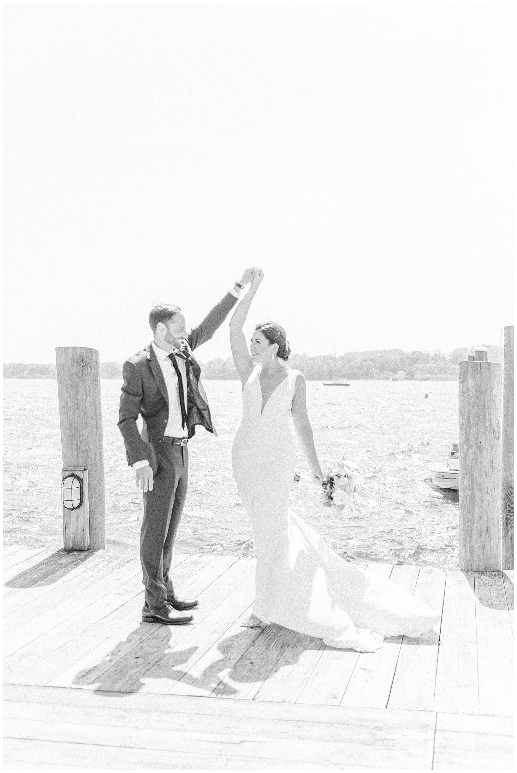 Couple dances on boat docks before seaside wedding in Bristol RI captured by Stephanie Berenson Photography