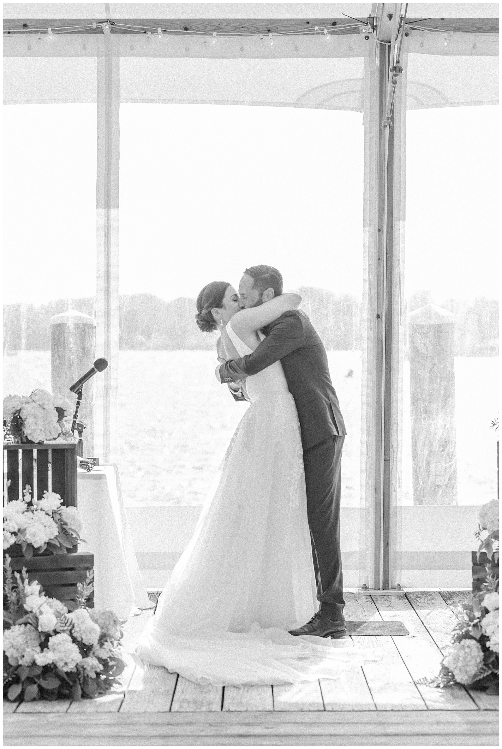 newlyweds kiss during Bristol Harbor Inn wedding ceremony 