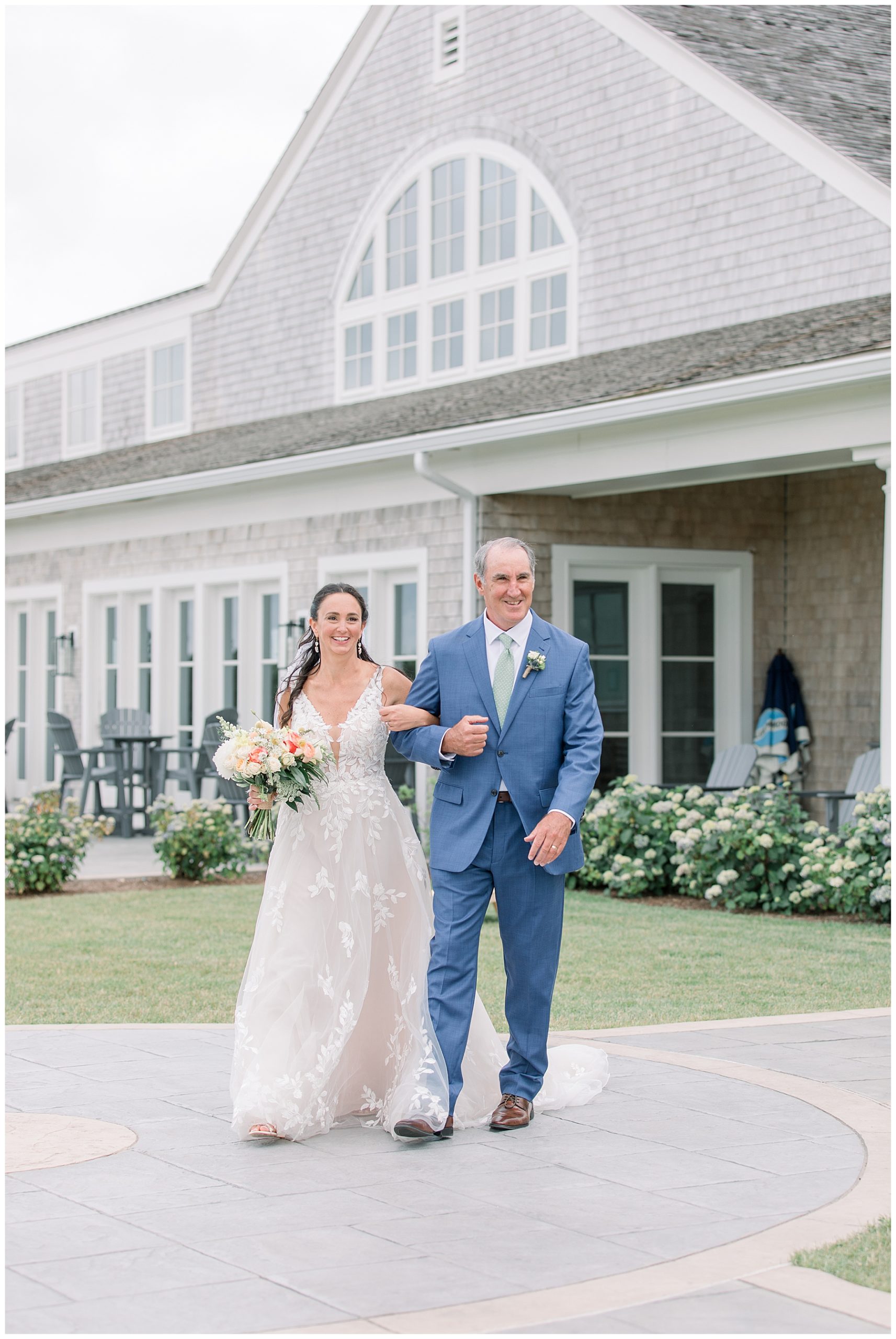 Father of the bride and daughter walking outside wedding venue in Plymouth MA