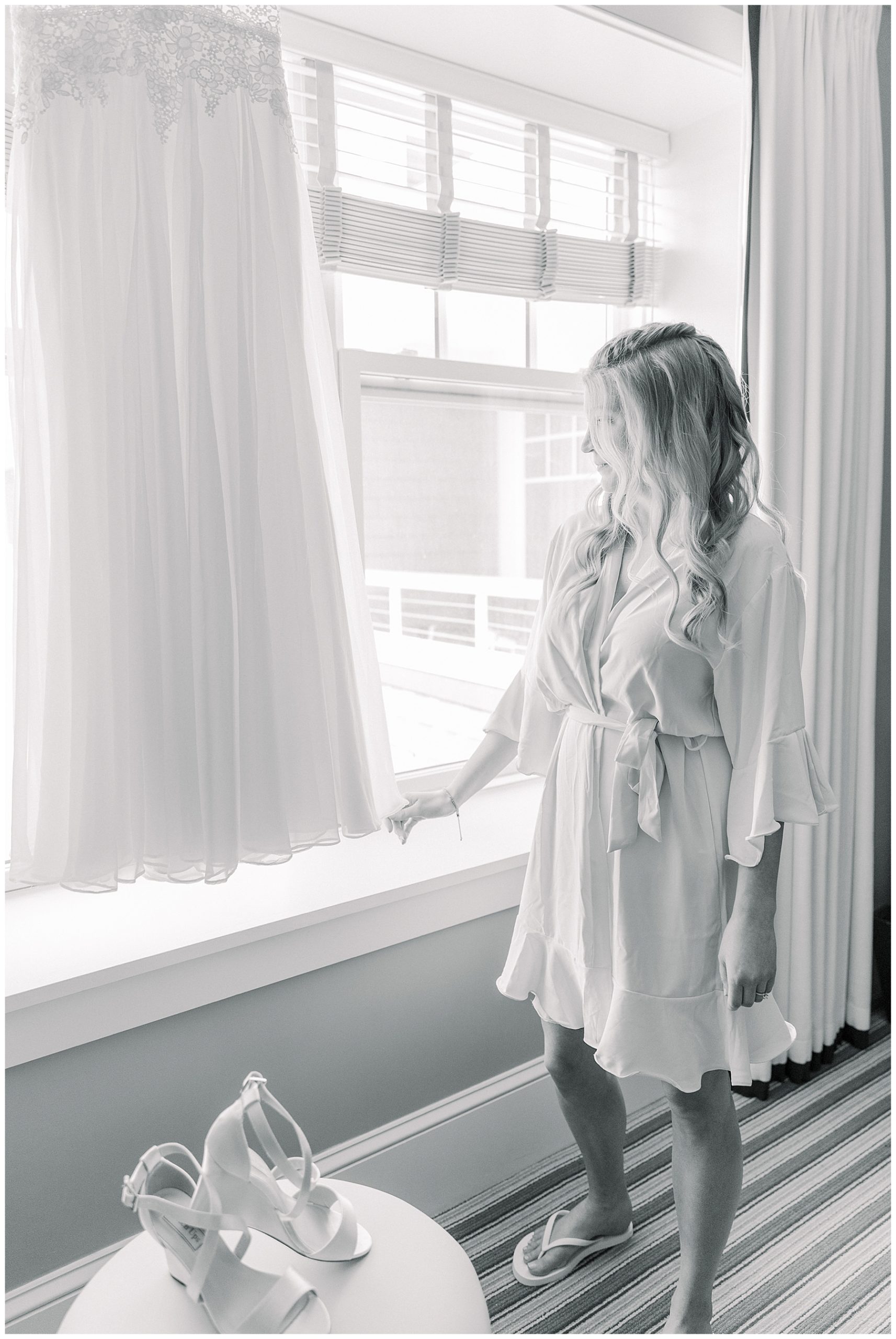 Bride stares out of window of Beauport Hotel in Gloucester MA