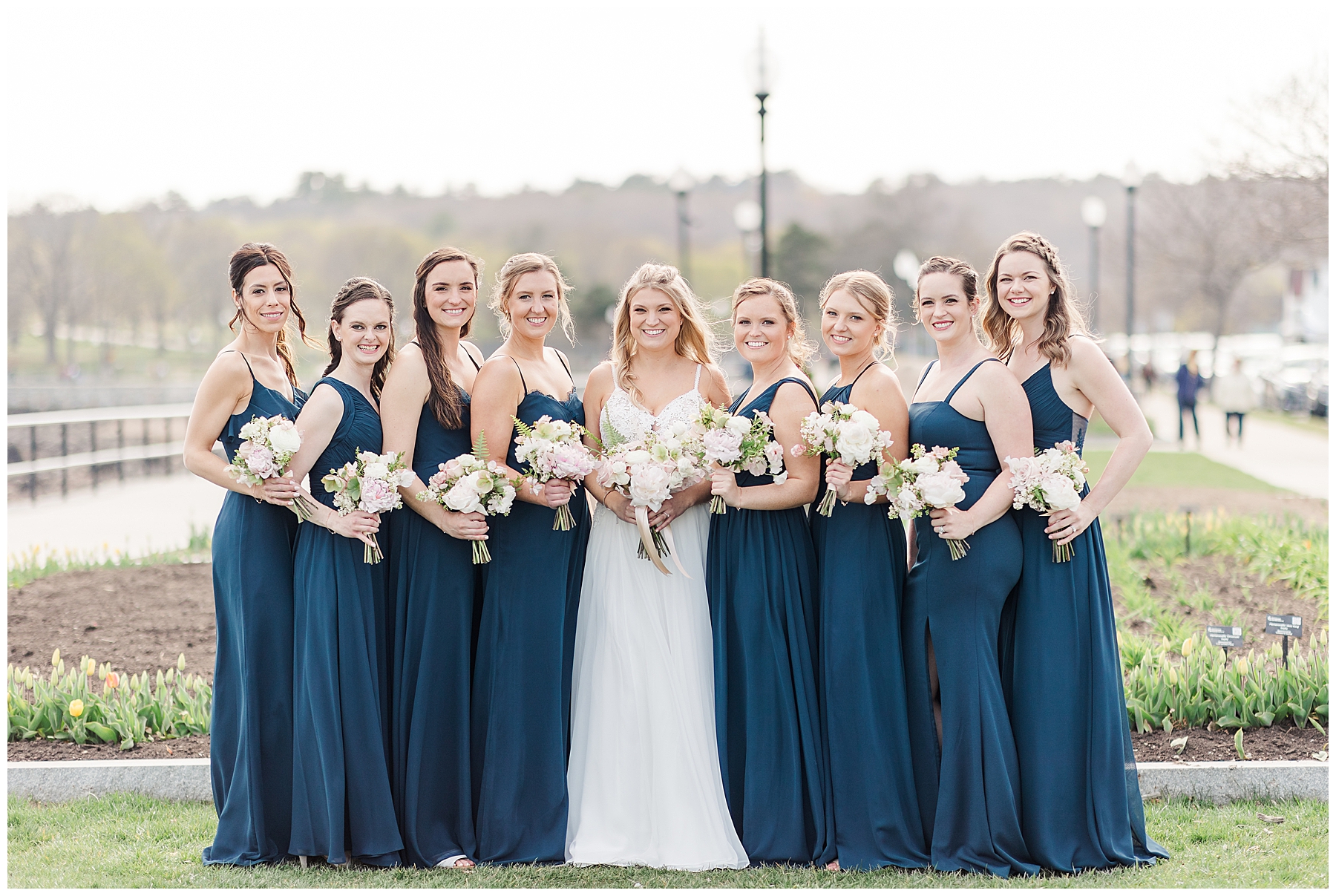 Bride and Bridesmaids stand with flower bouquets before wedding ceremony in Gloucester MA