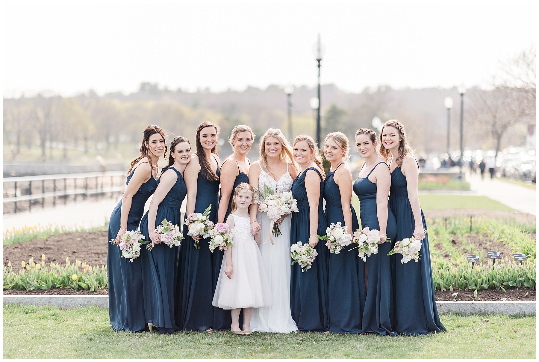 Bride and Bridesmaids stand with flower bouquets before wedding ceremony in Gloucester MA photographed by Stephanie Berenson