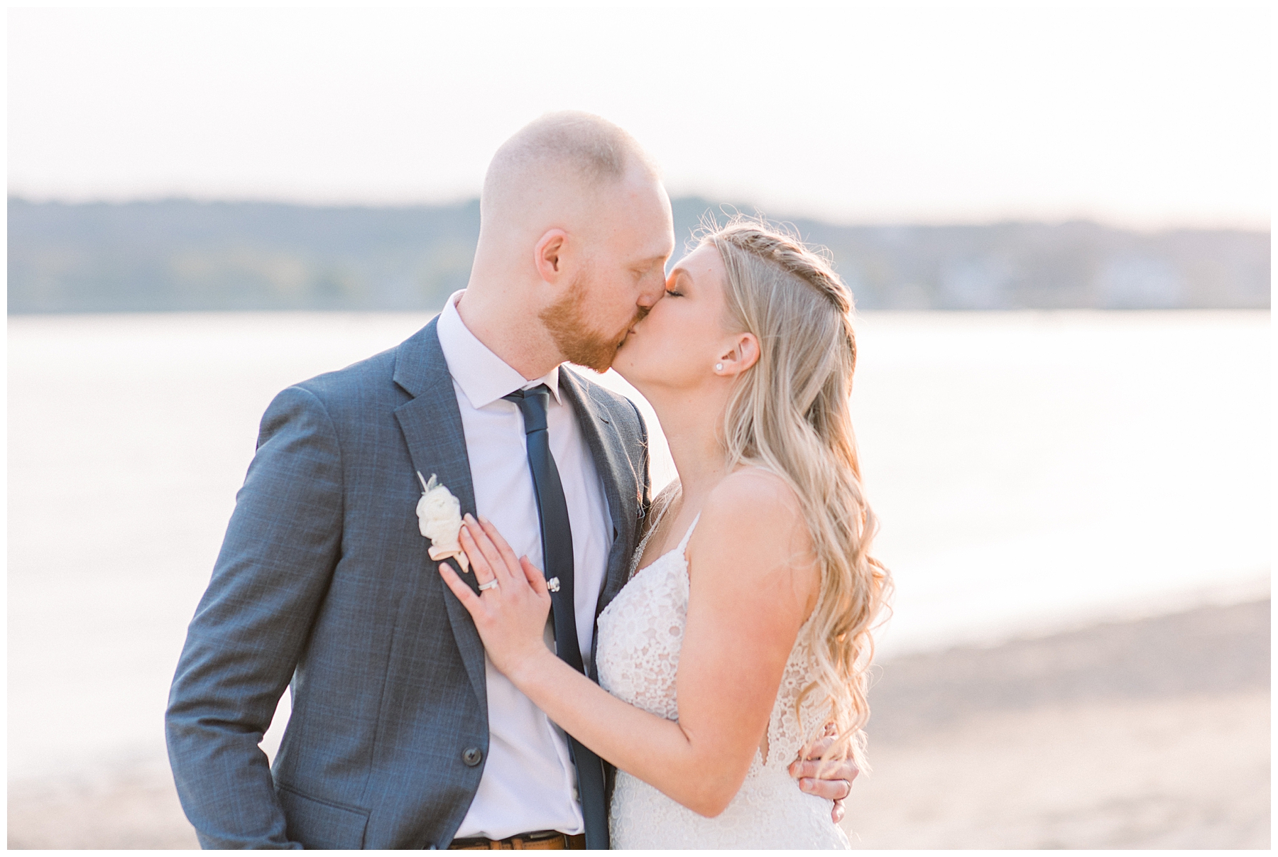 bride + groom kiss on beach in Gloucester MA captured by Chelsea Morton Photography