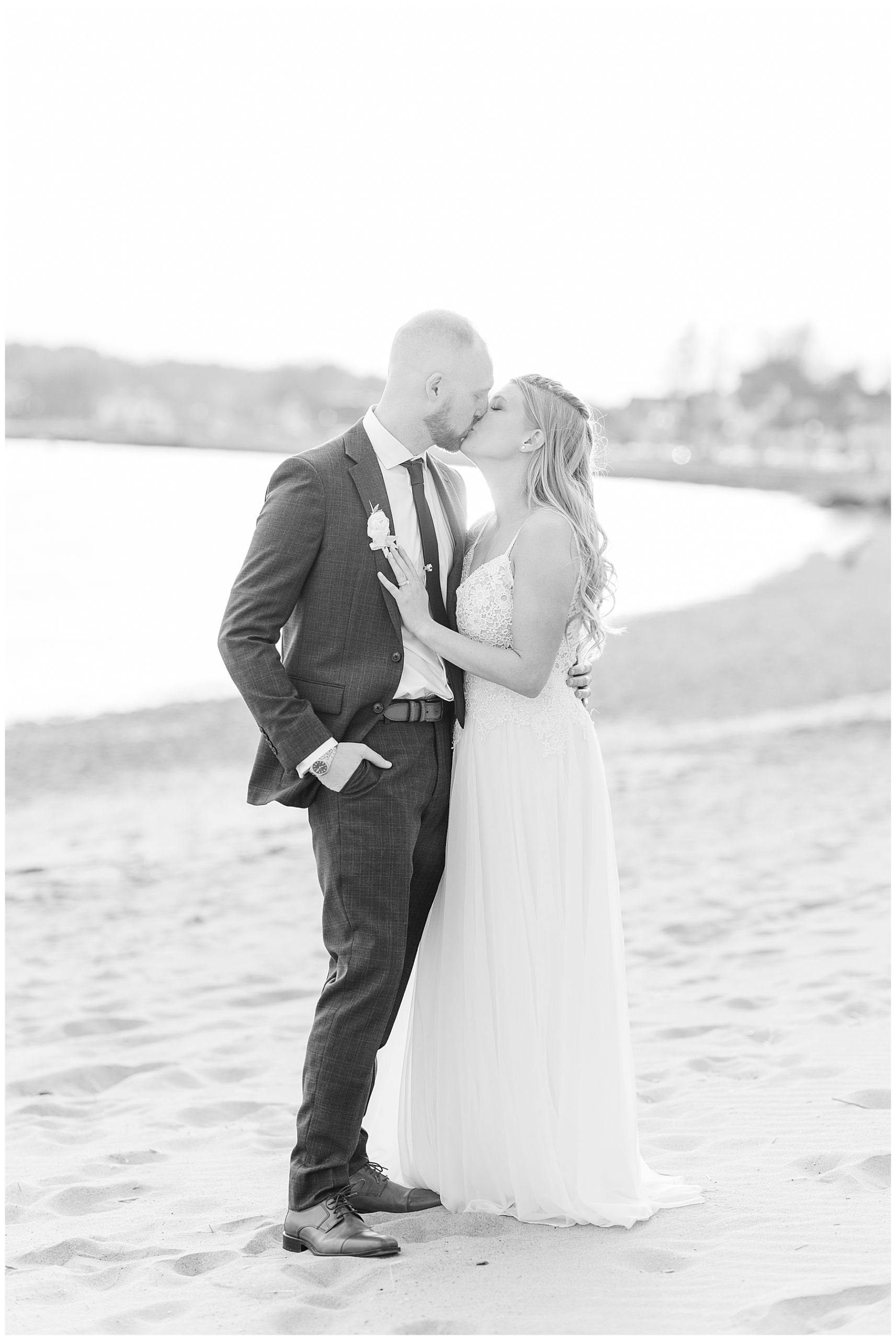 bride + groom kiss on beach in Gloucester MA near the Beauport Hotel