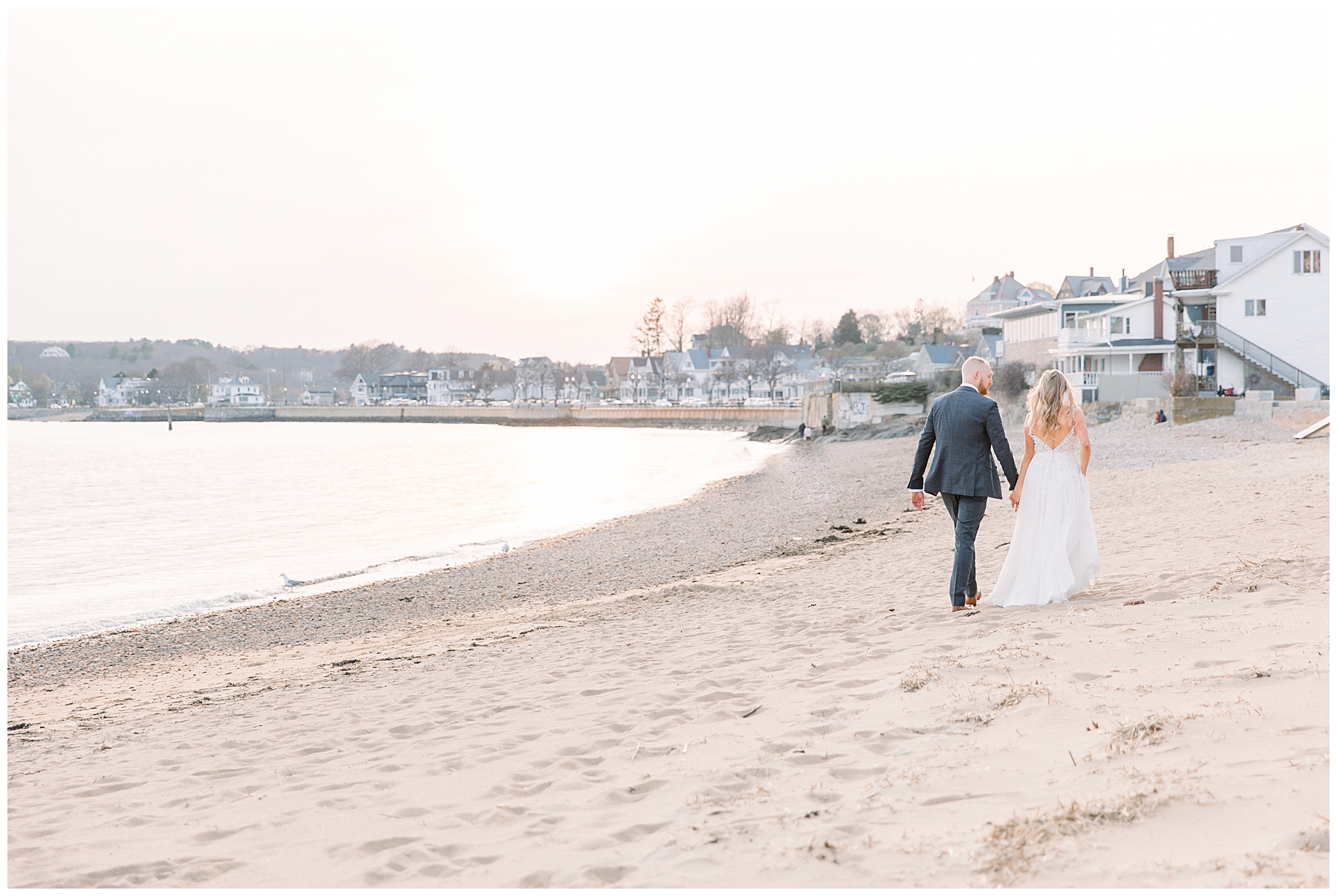 Newlyweds on the beach at Beauport Hotel wedding in Gloucester MA captured by Chelsea Morton Photography