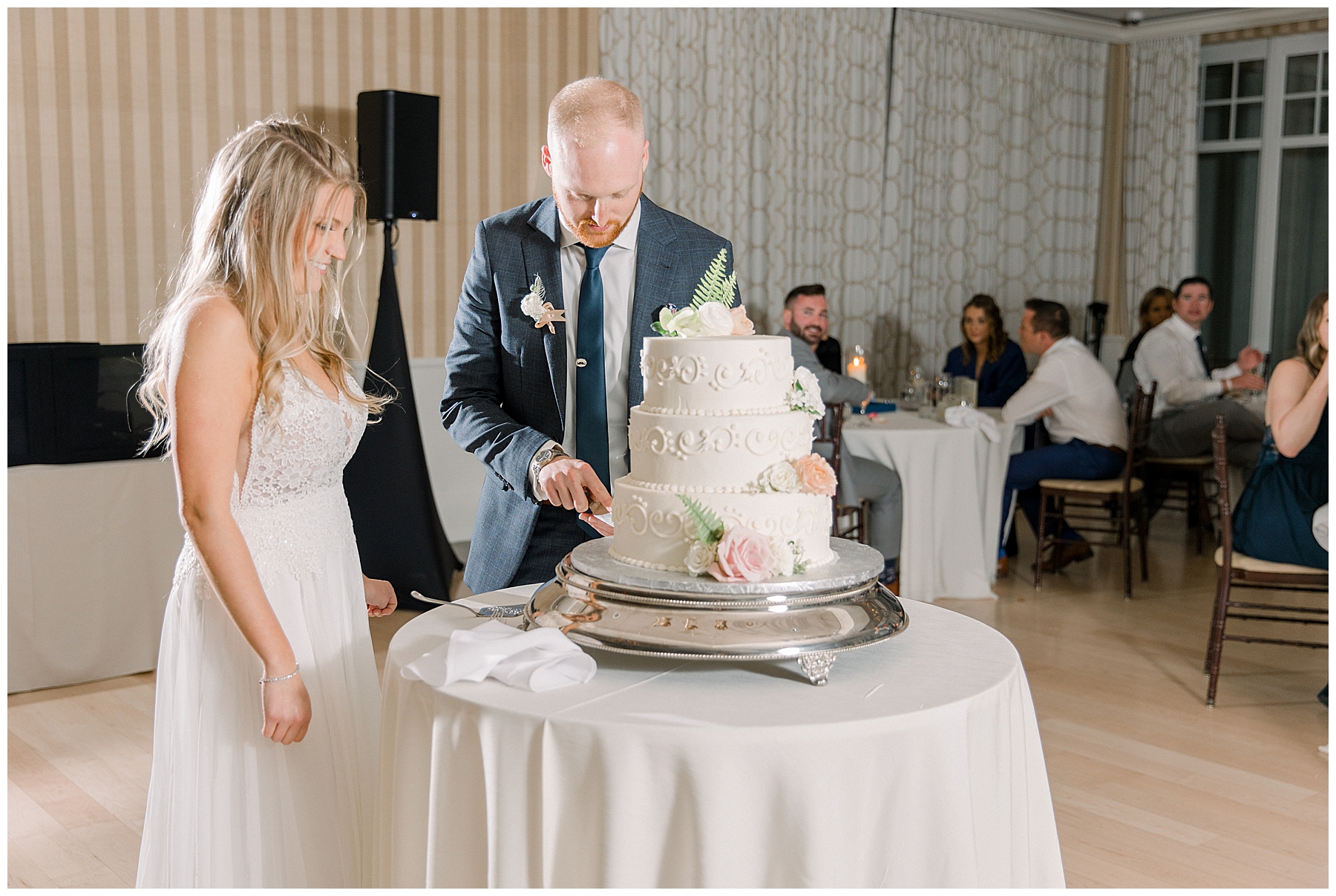 Bride + groom cut wedding cake at reception in Gloucester MA