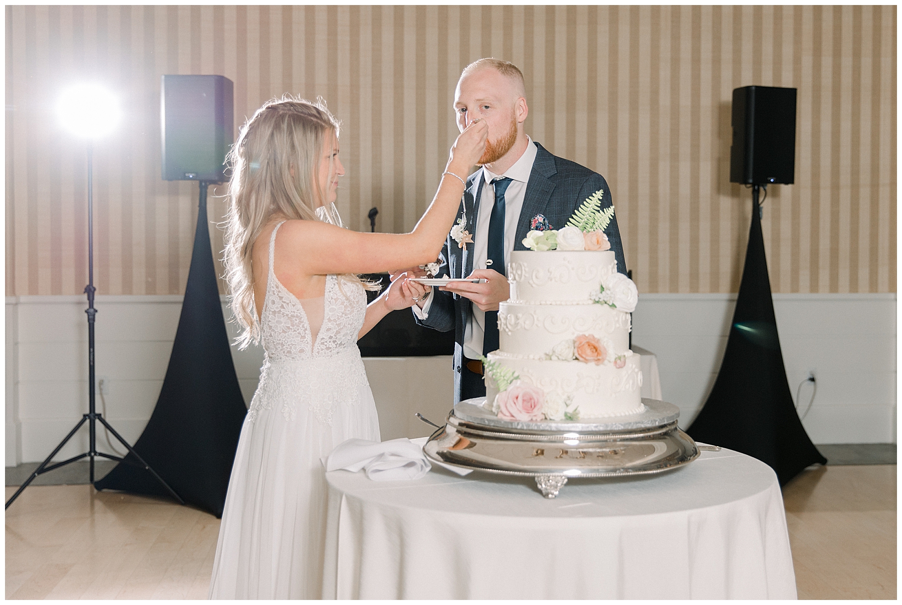 Bride + groom cut wedding cake at reception in Gloucester MA