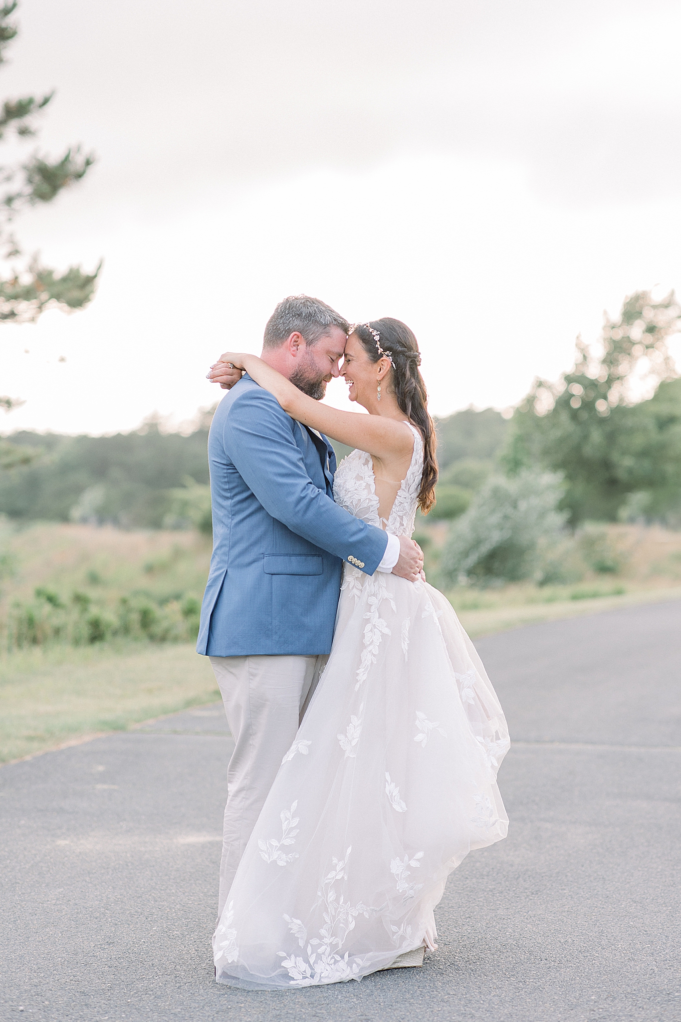 bride and groom hug nose to nose during sunset photos