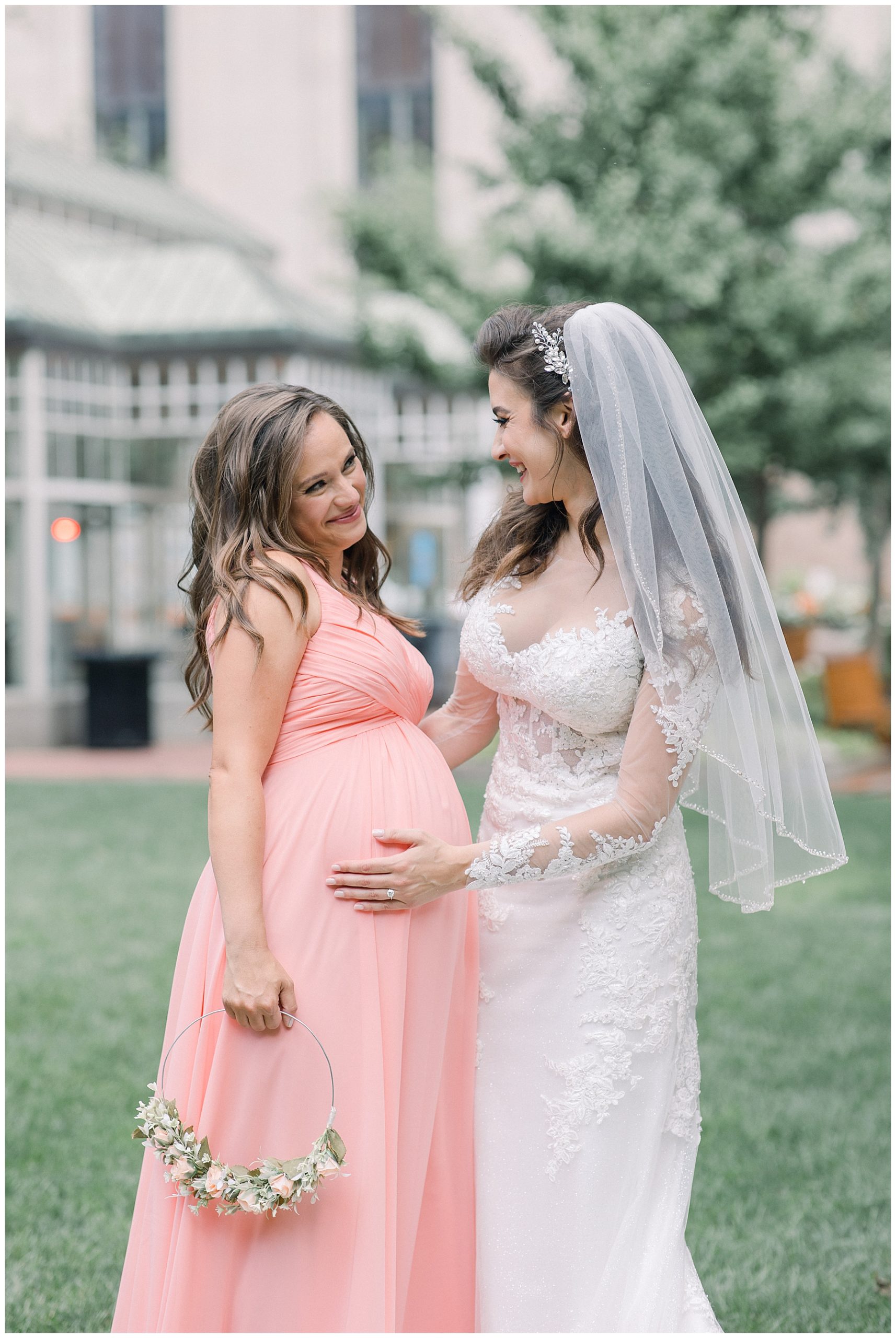 bride with expecting bridesmaid
