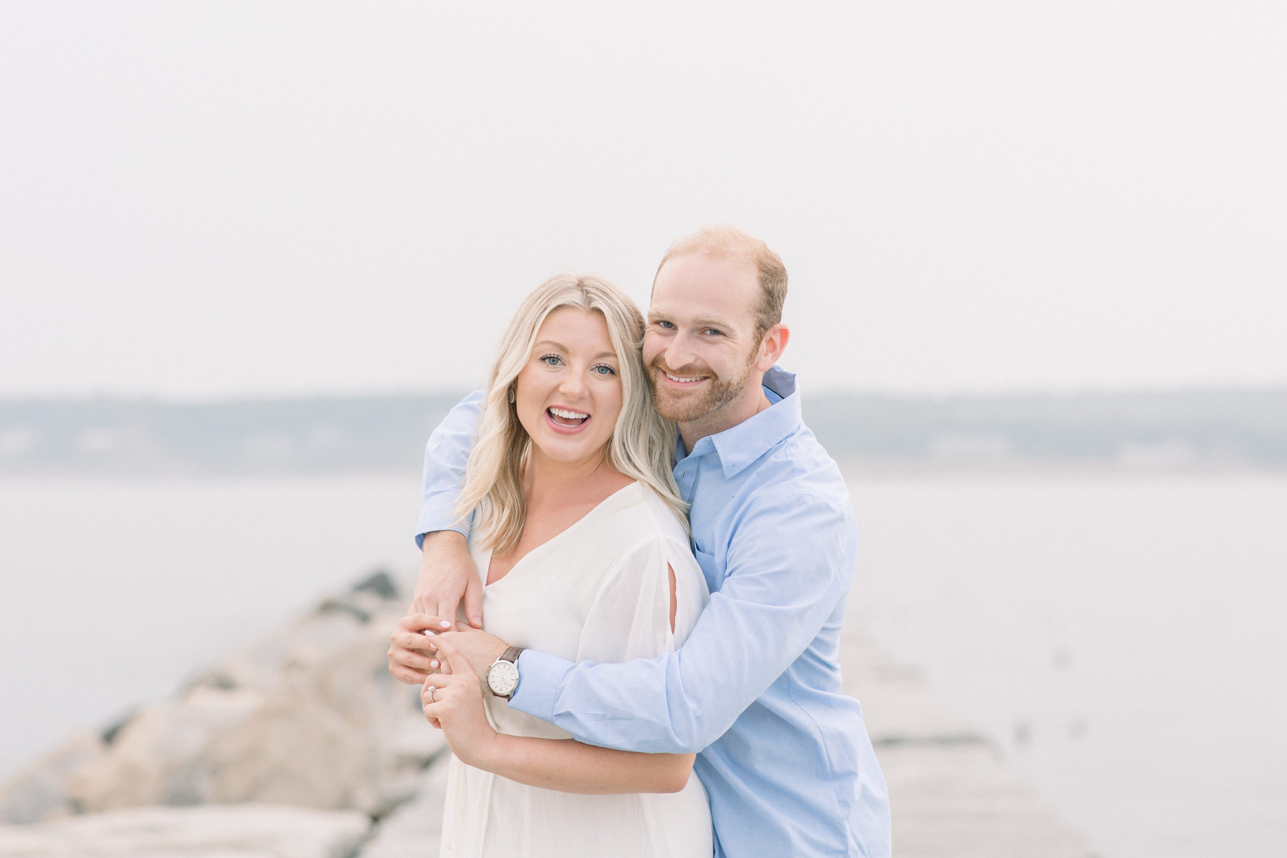 Couple takes engagement photos on the beach