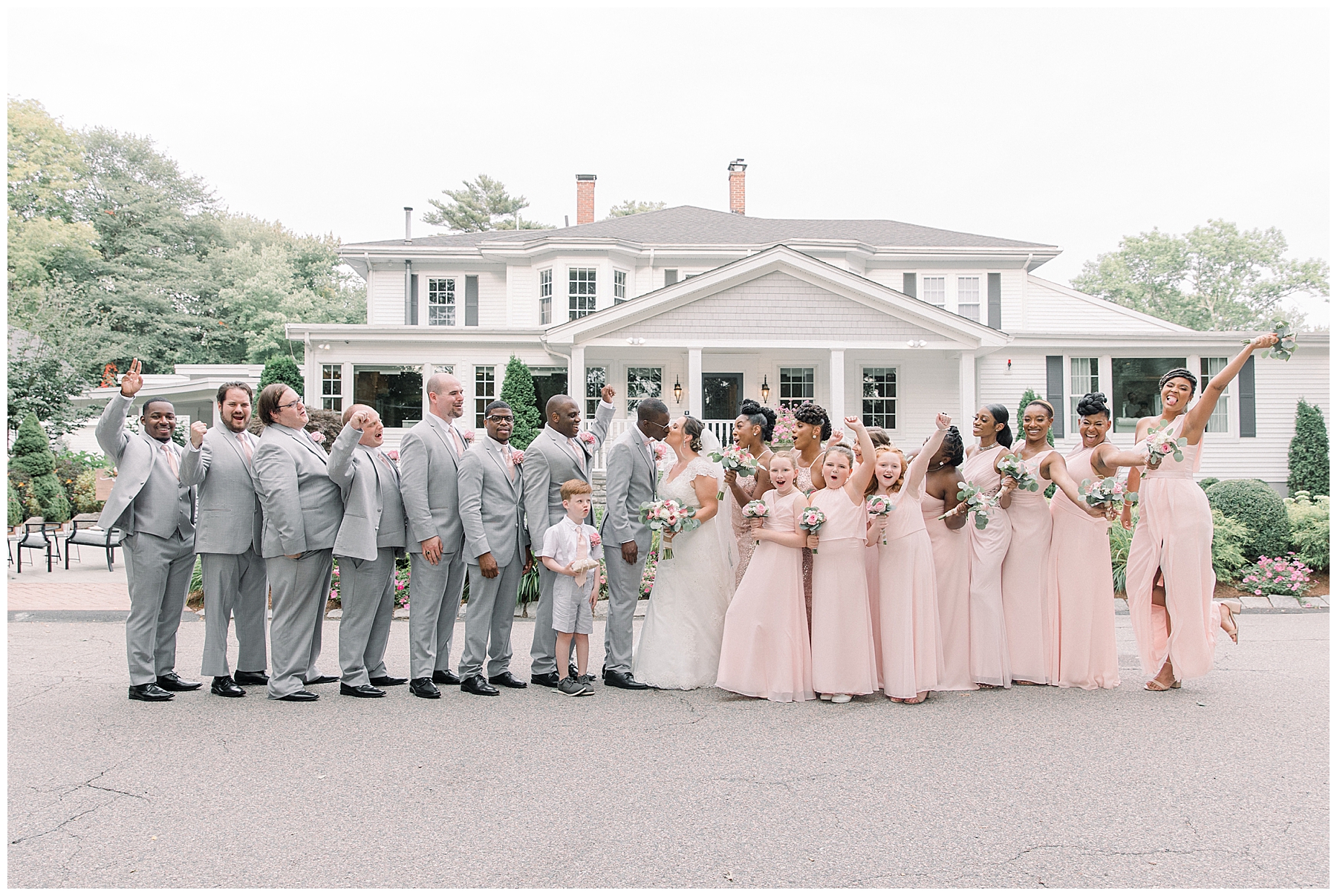 groomsmen in grey suits and bridesmaids in dusty pink dresses