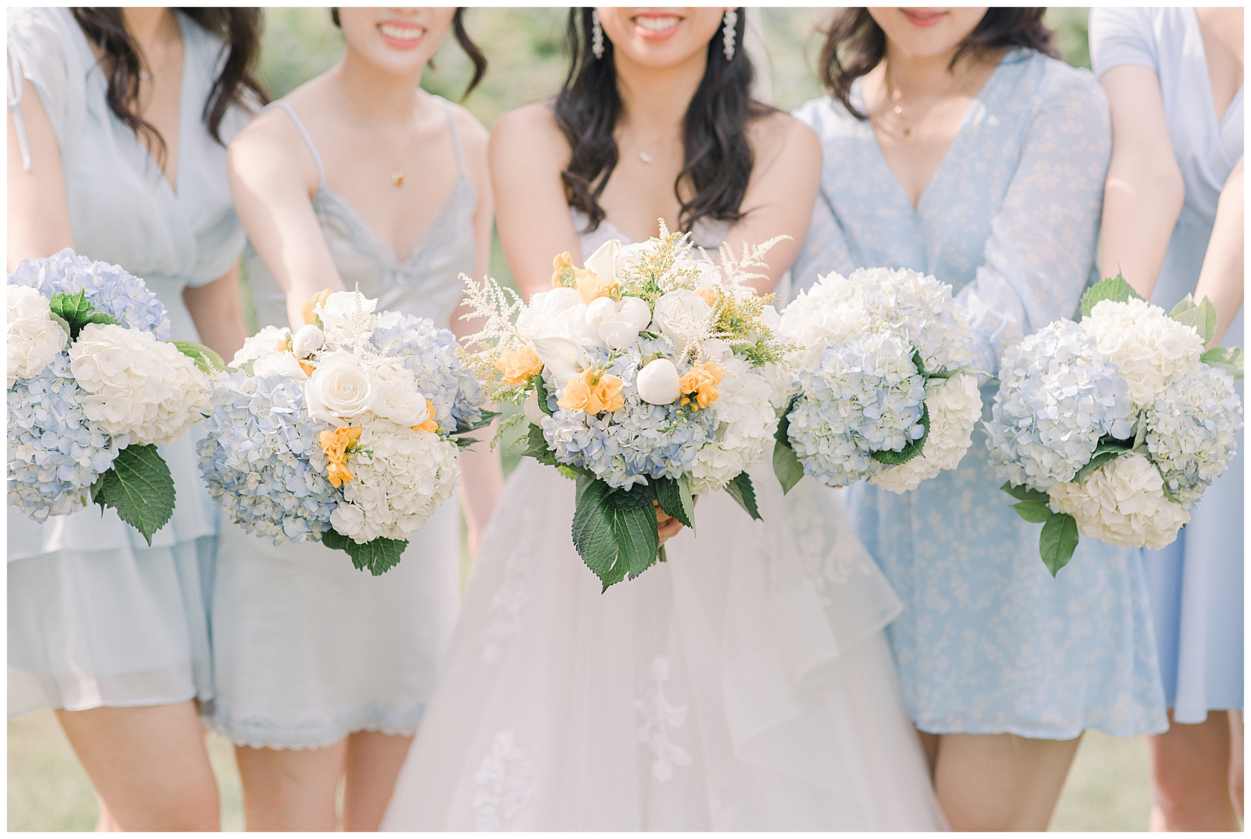 bride and bridesmaid hold out wedding bouquets 