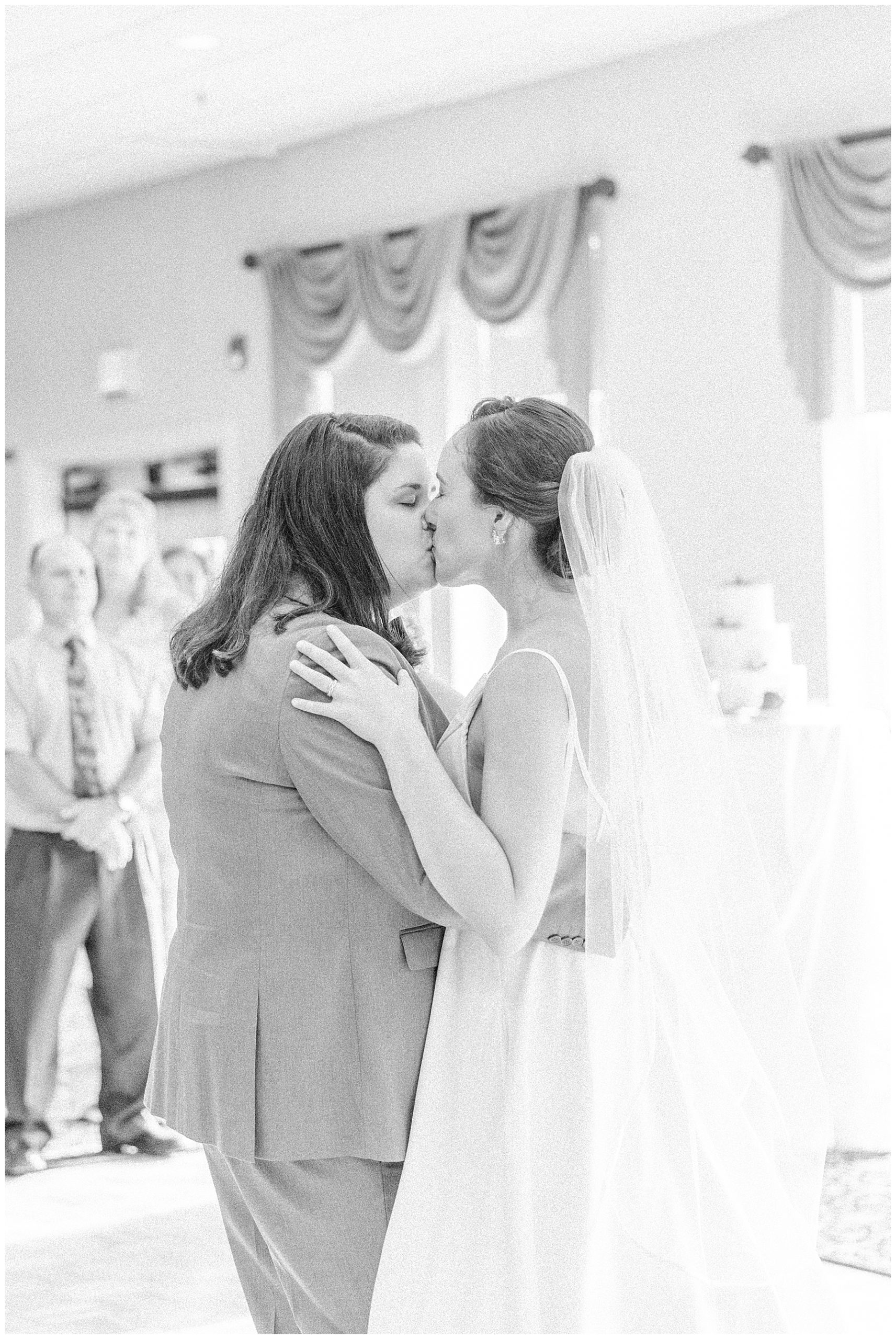 newlyweds kiss at wedding reception