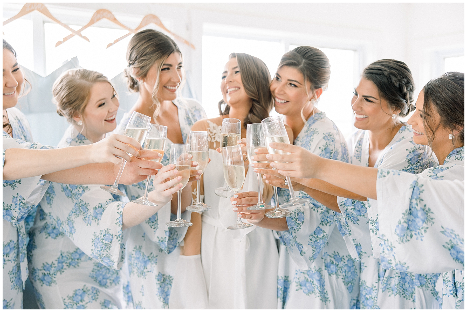 bride and bridesmaids drink champagne as they get ready for MA wedding