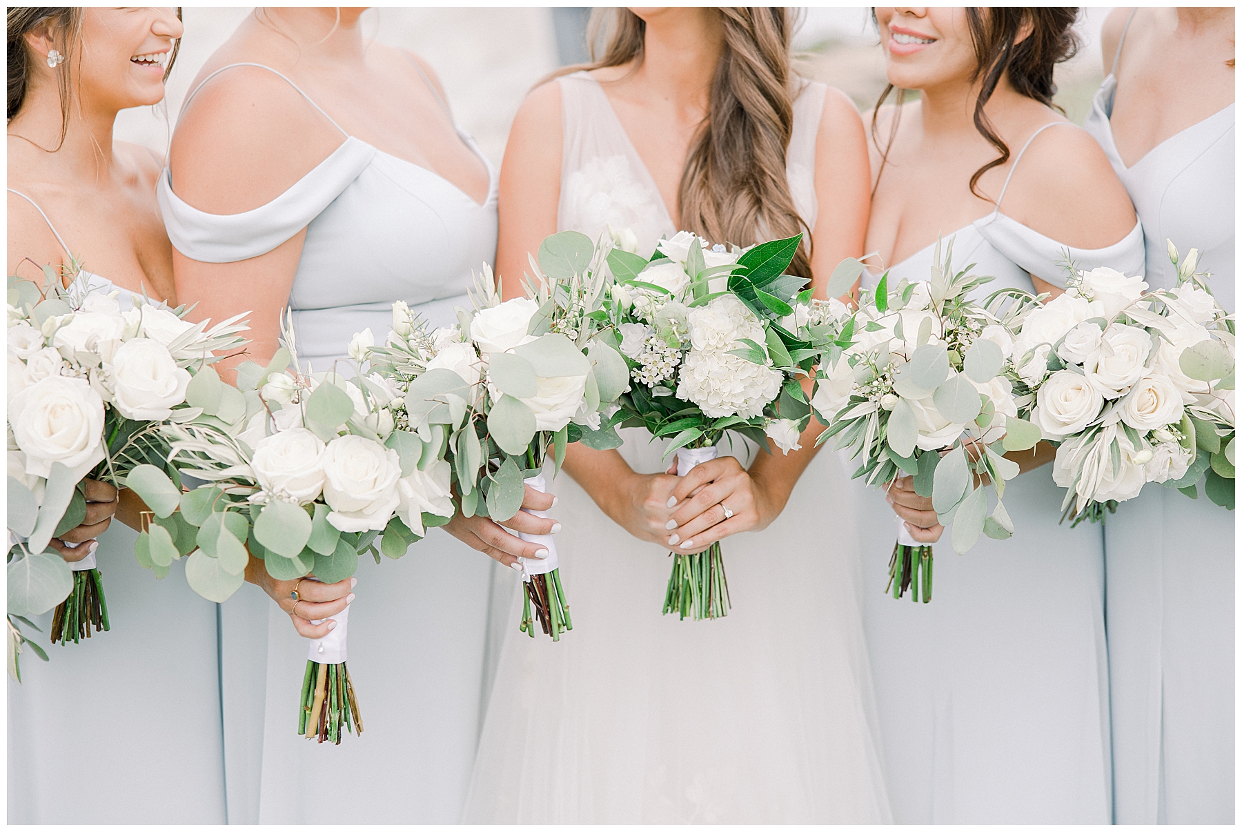 bride and bridesmaids holding classic white wedding bouquets