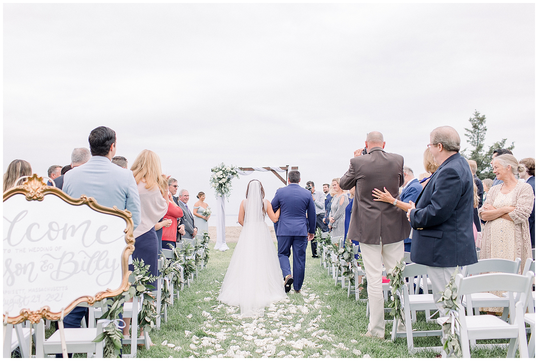 father of the bride walks daughter down the aisle at outdoor MA wedding