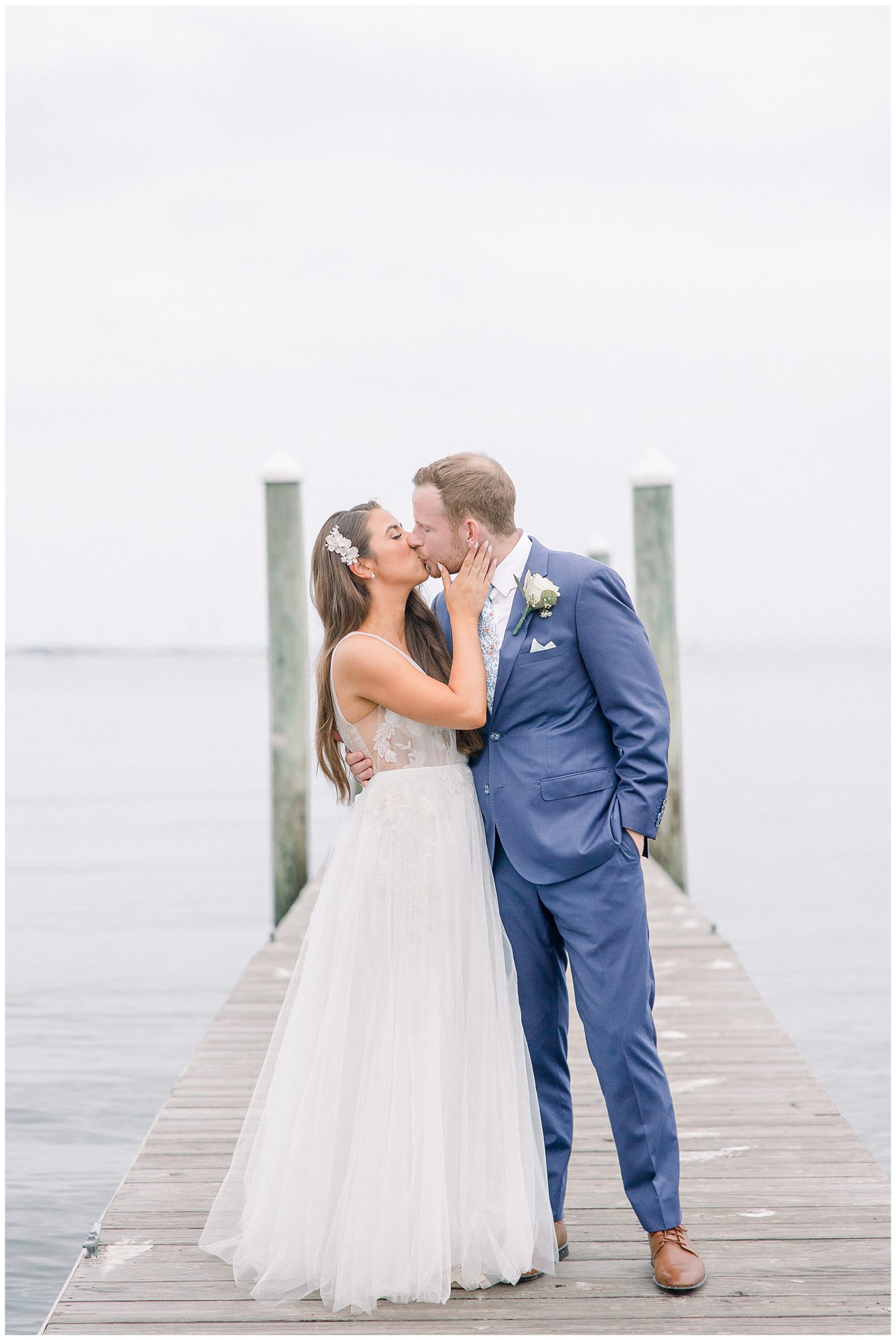 newlyweds kiss on the dock after Shining Tides Wedding in MA