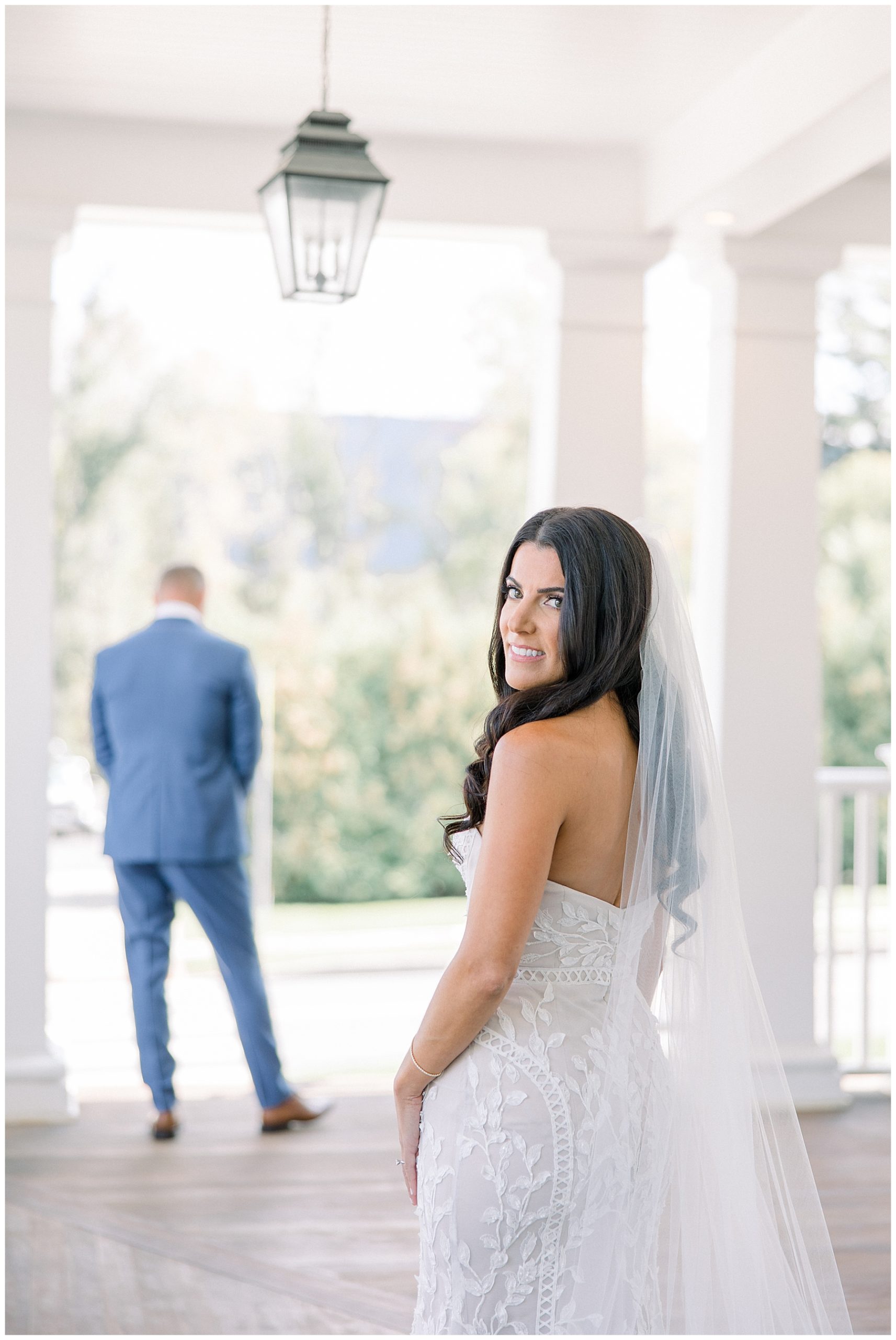 bride waiting for her future husband to turn around during first look