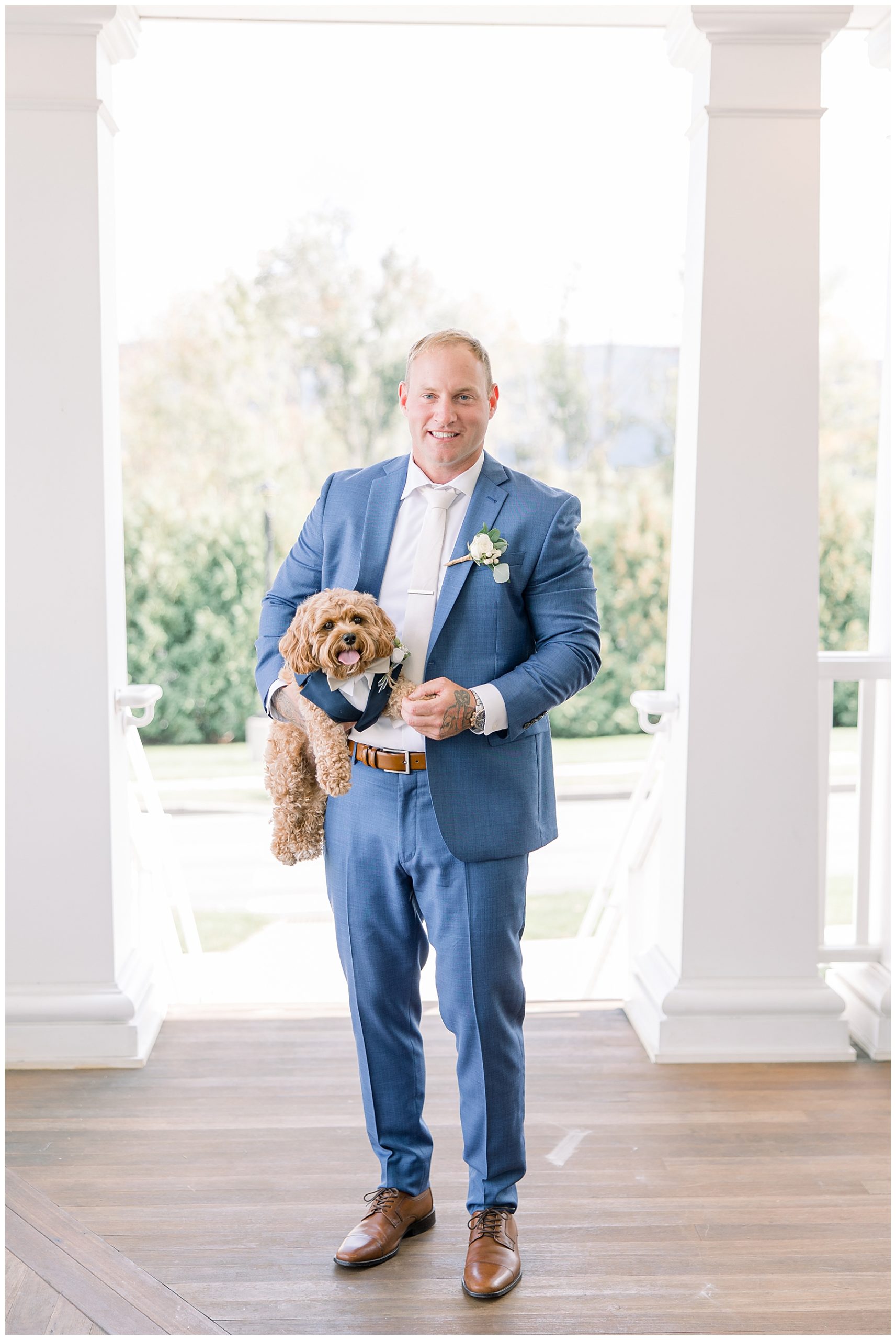 groom with his dog in tux