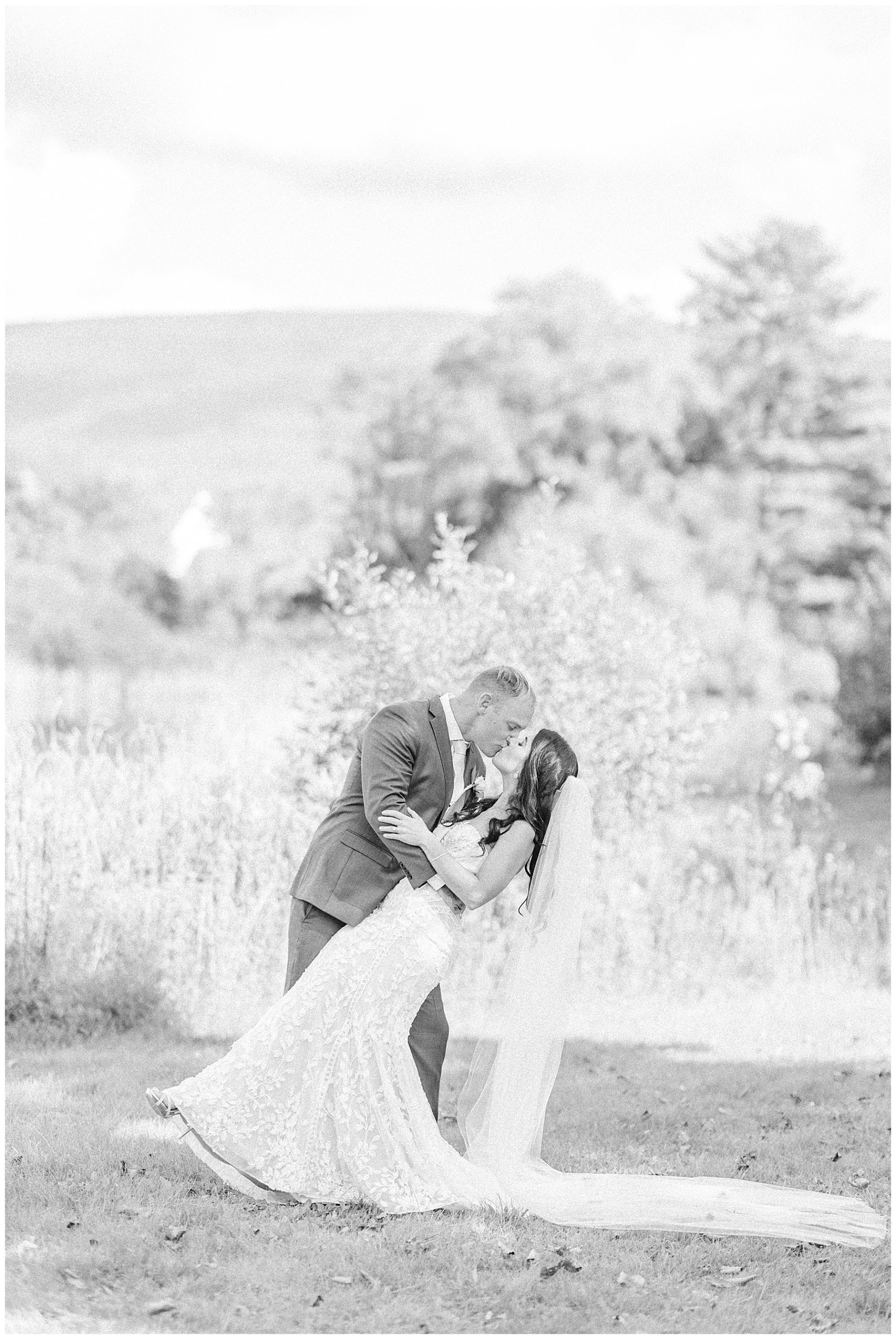 groom dips his bride to give her kiss