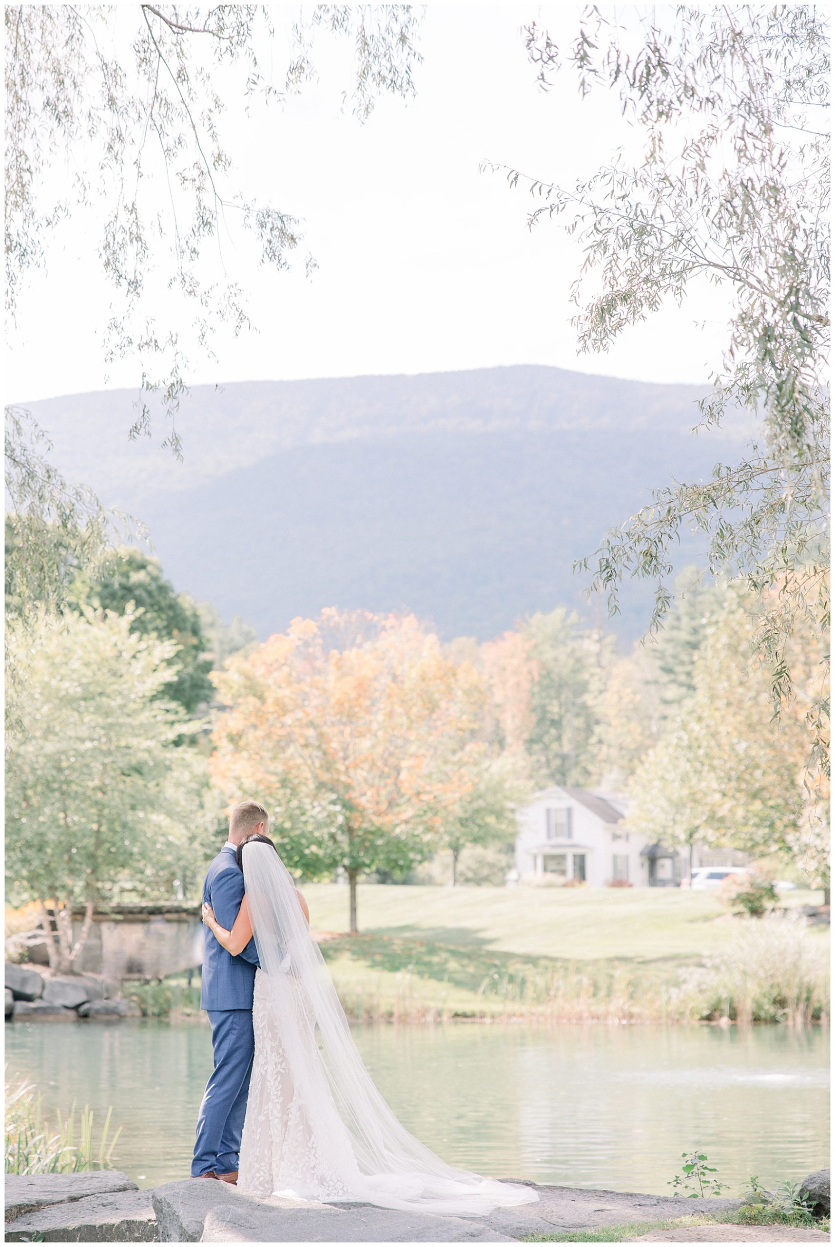 couple look at the Vermont mountains during their wedding portraits