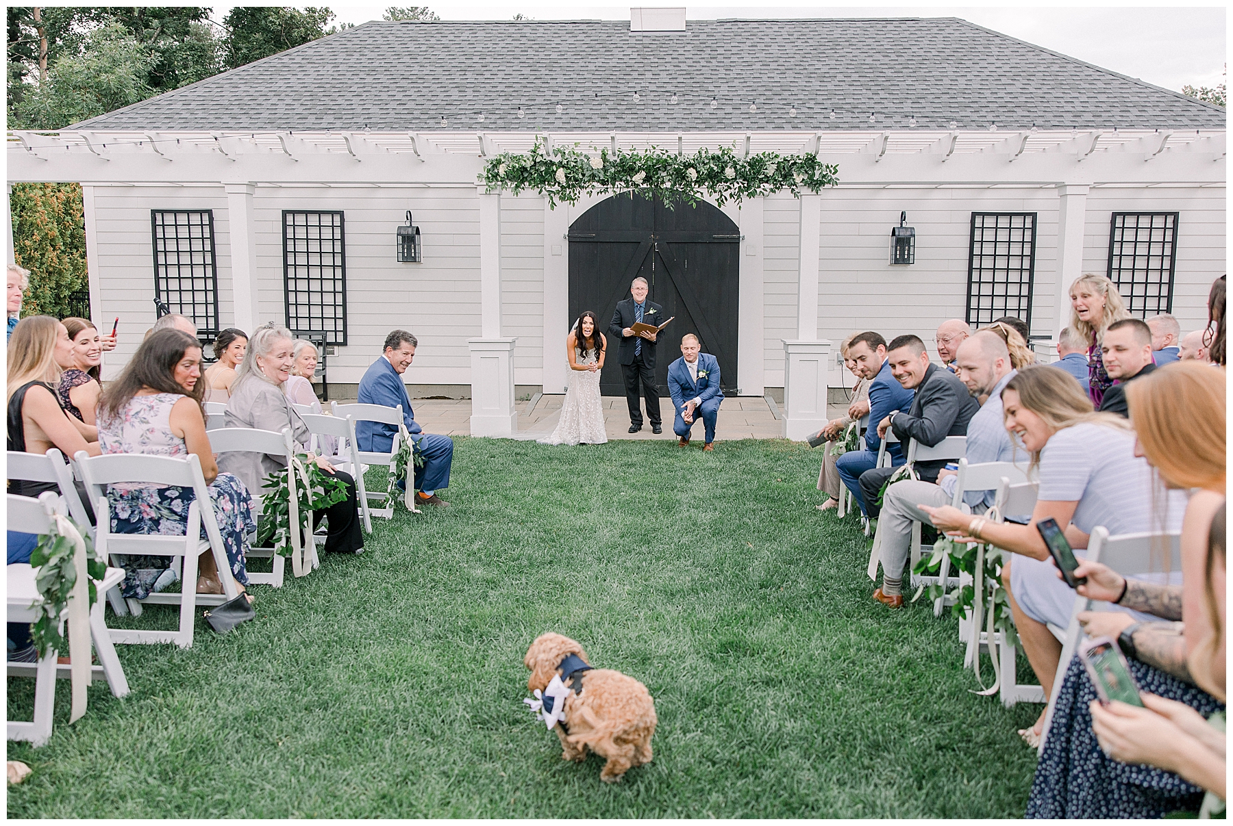 dog and ring bearer runs down the aisle to deliver wedding rings