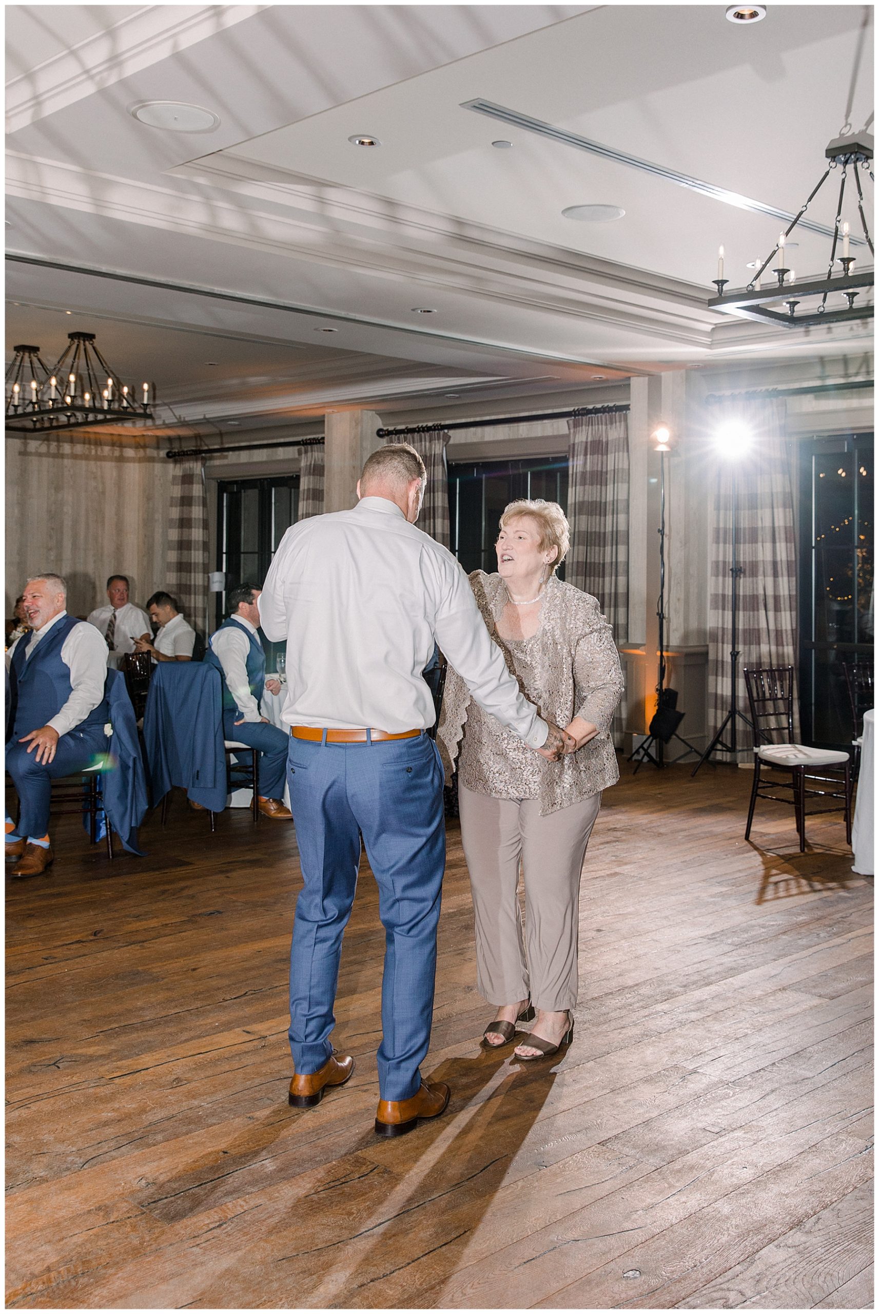 groom dances with his mother at reception