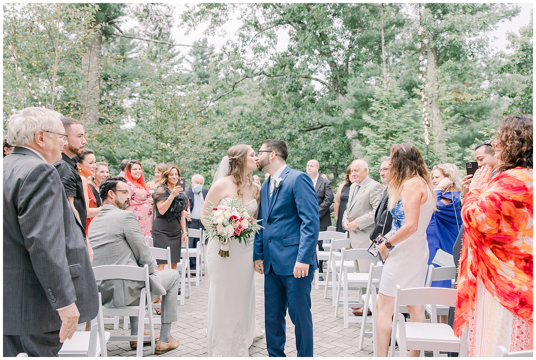 couple kiss after outdoor wedding ceremony at the Lakeview Pavilion in MA