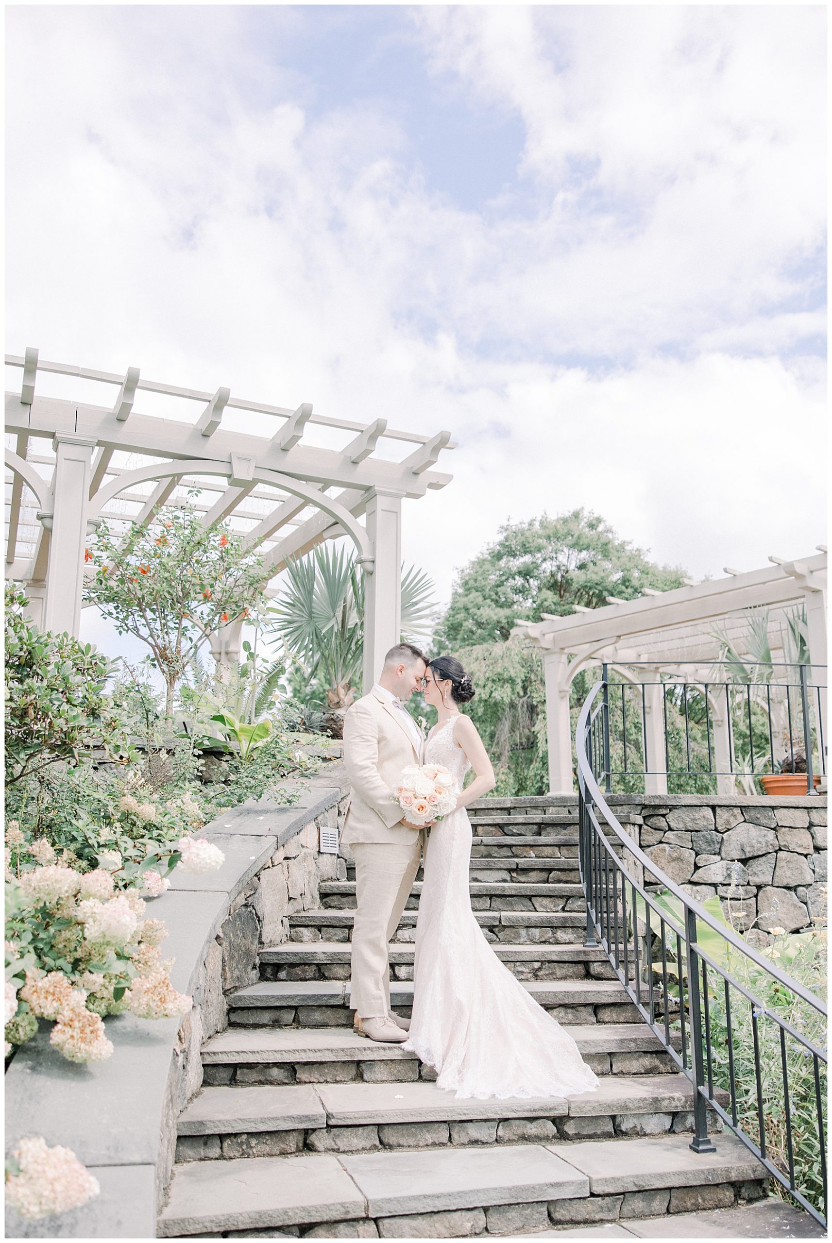 newlyweds on winding stone staircase 