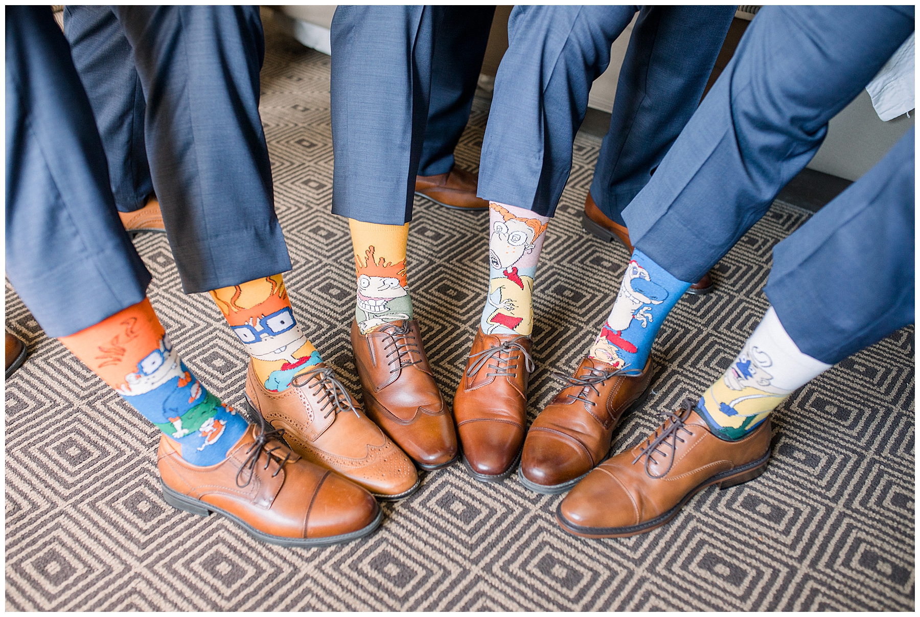 Groom and Groomsmen show off socks before wedding ceremony