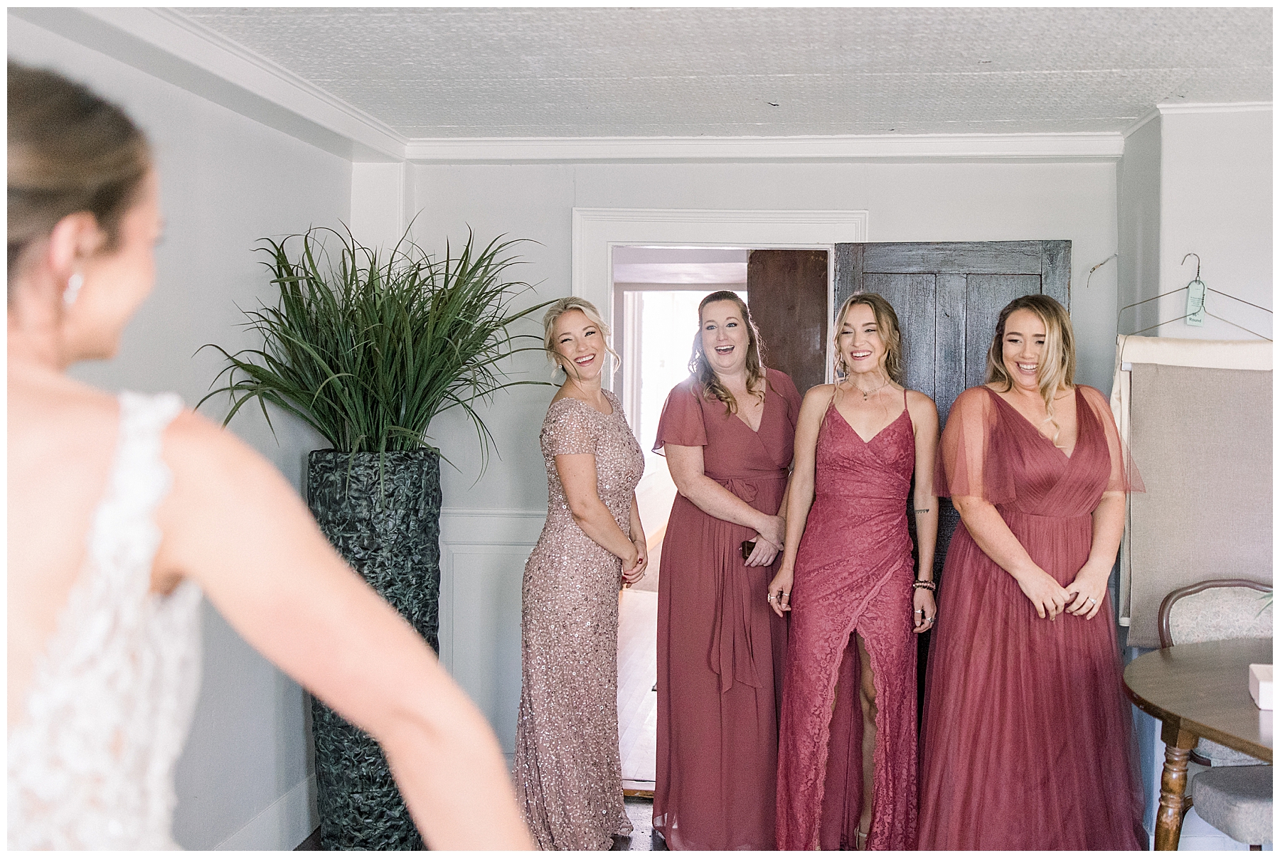 bridesmaids see bride for the first time in wedding dress