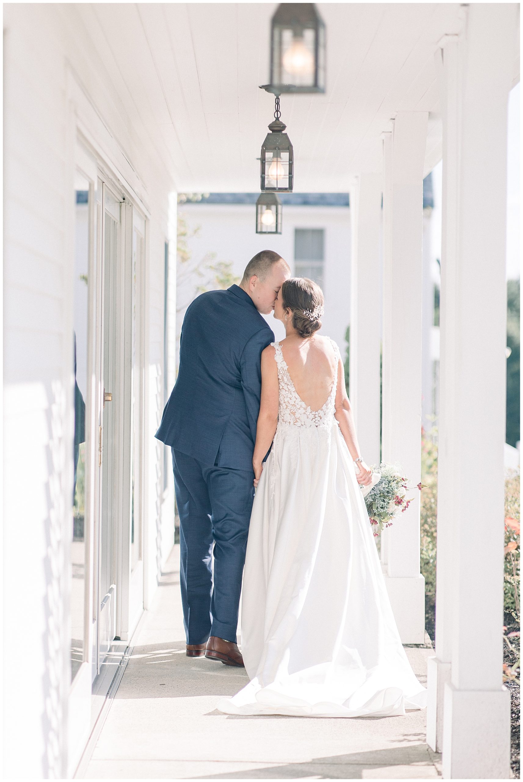 couple kiss on the porch before wedding 