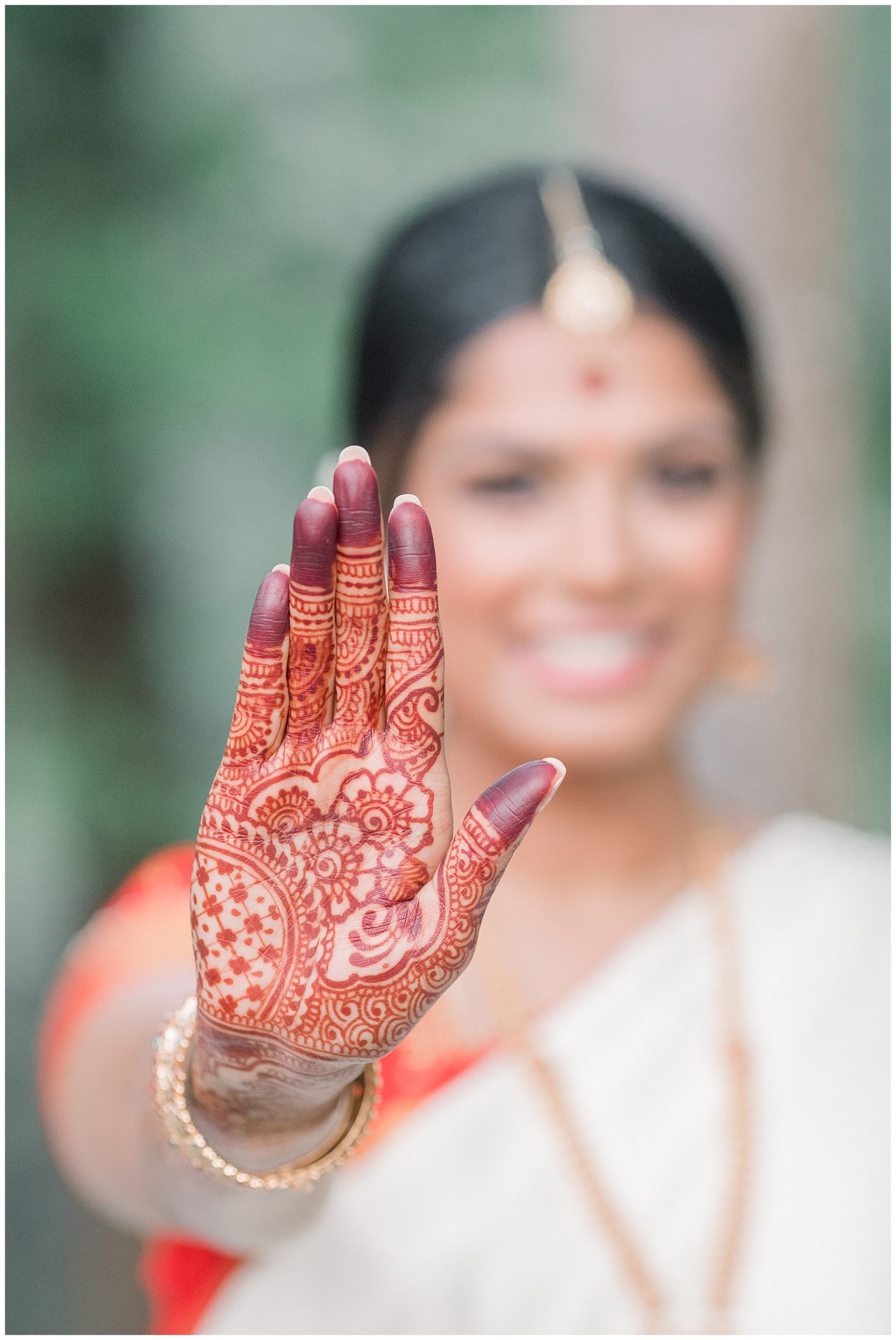 bride shows off henna art on hand