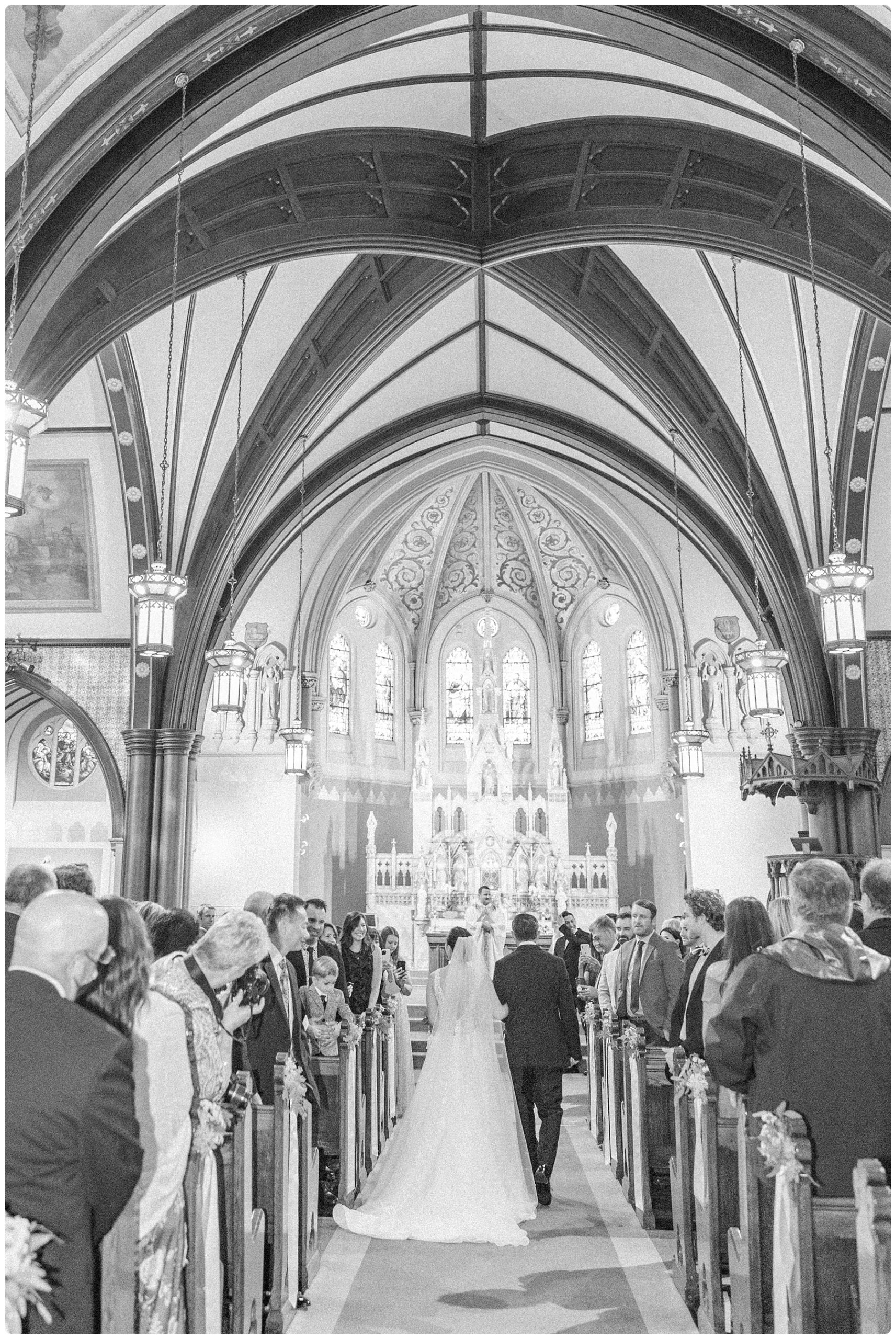 bride walking down aisle with father