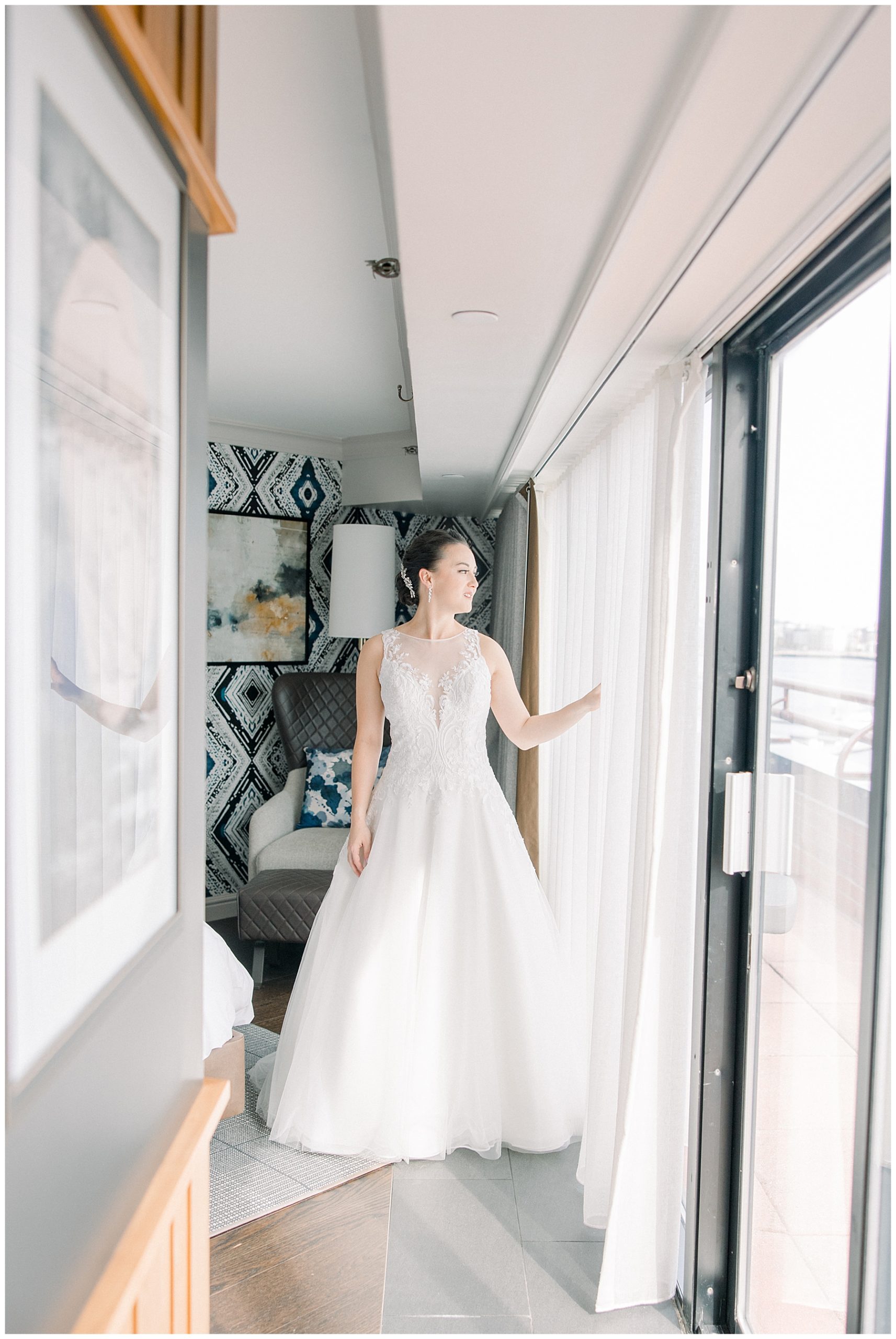 bride in wedding dress looking out of the window at Boston Marriott Long Wharf