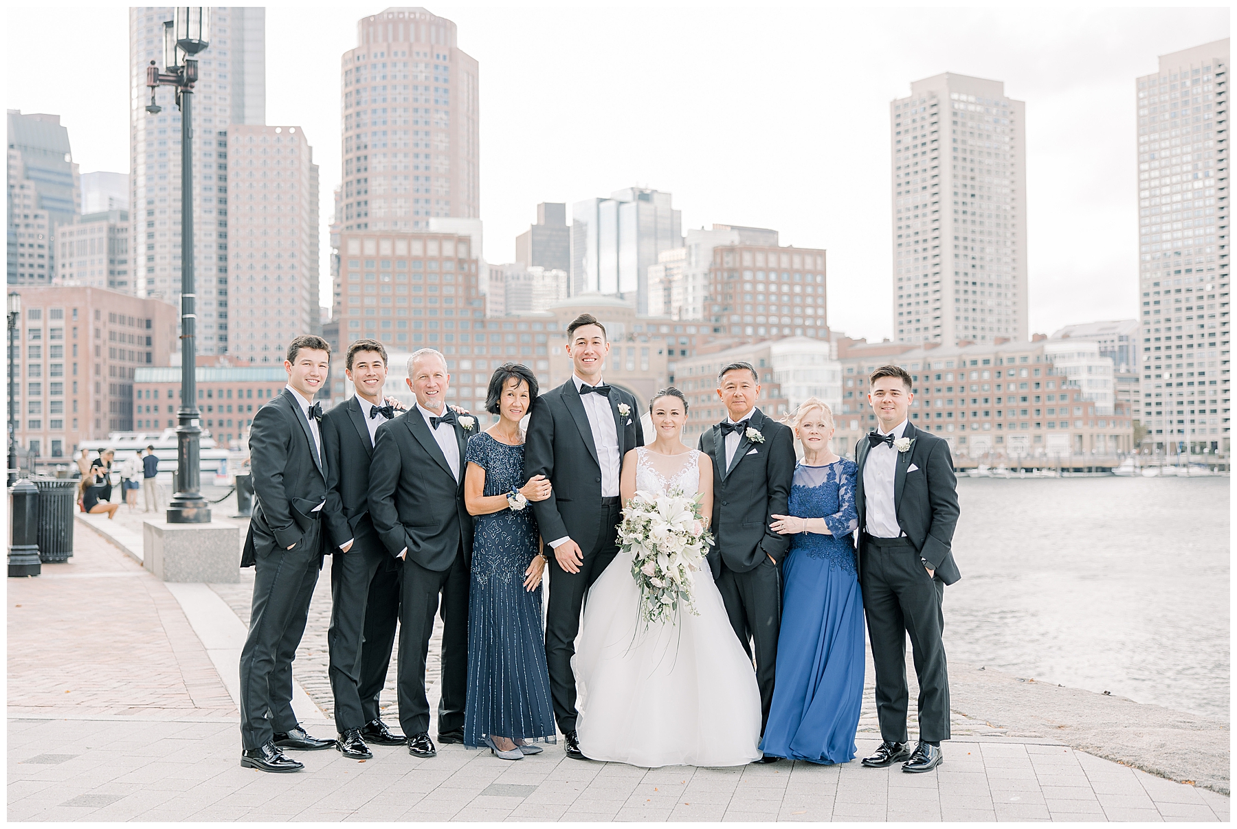 bride and groom with family at Fan Pier Park in Boston, MA