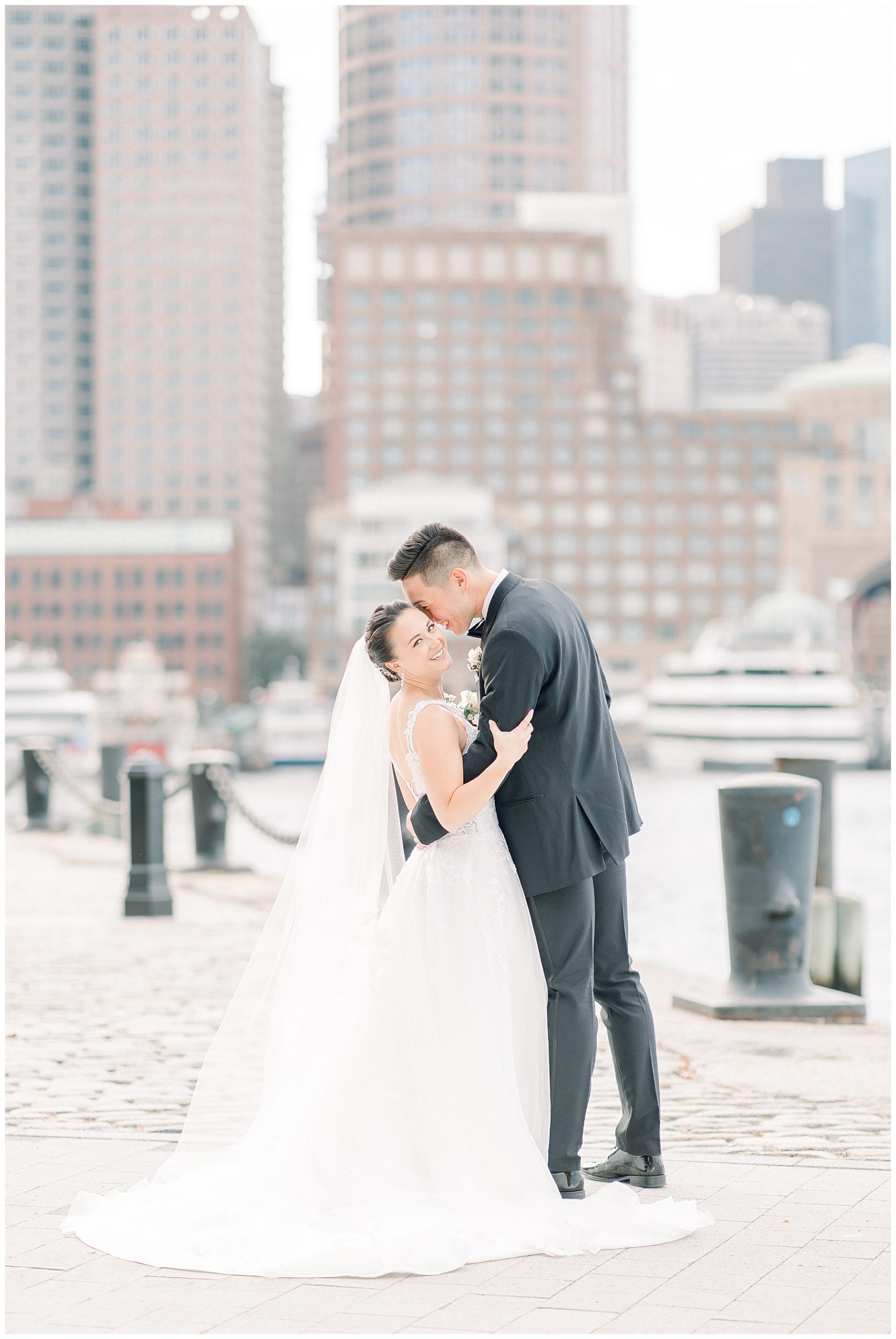 newlyweds kiss at Fan pier park in Boston MA