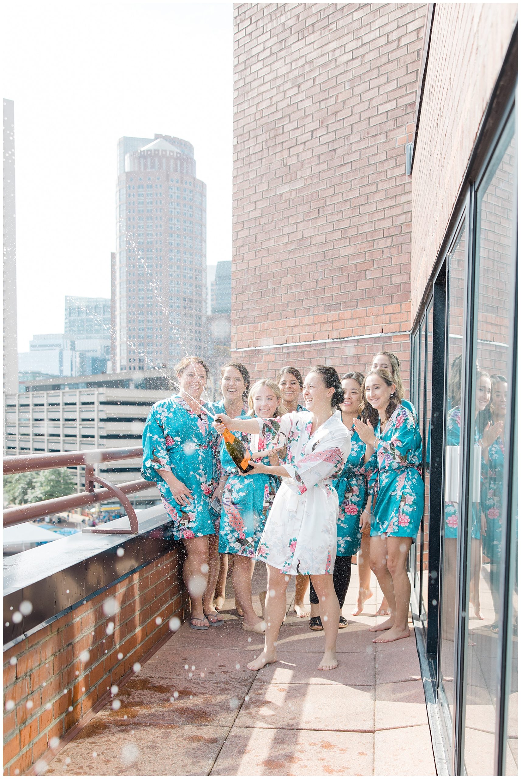 bridesmaids on balcony in bridal suite at Boston Marriott Long Wharf