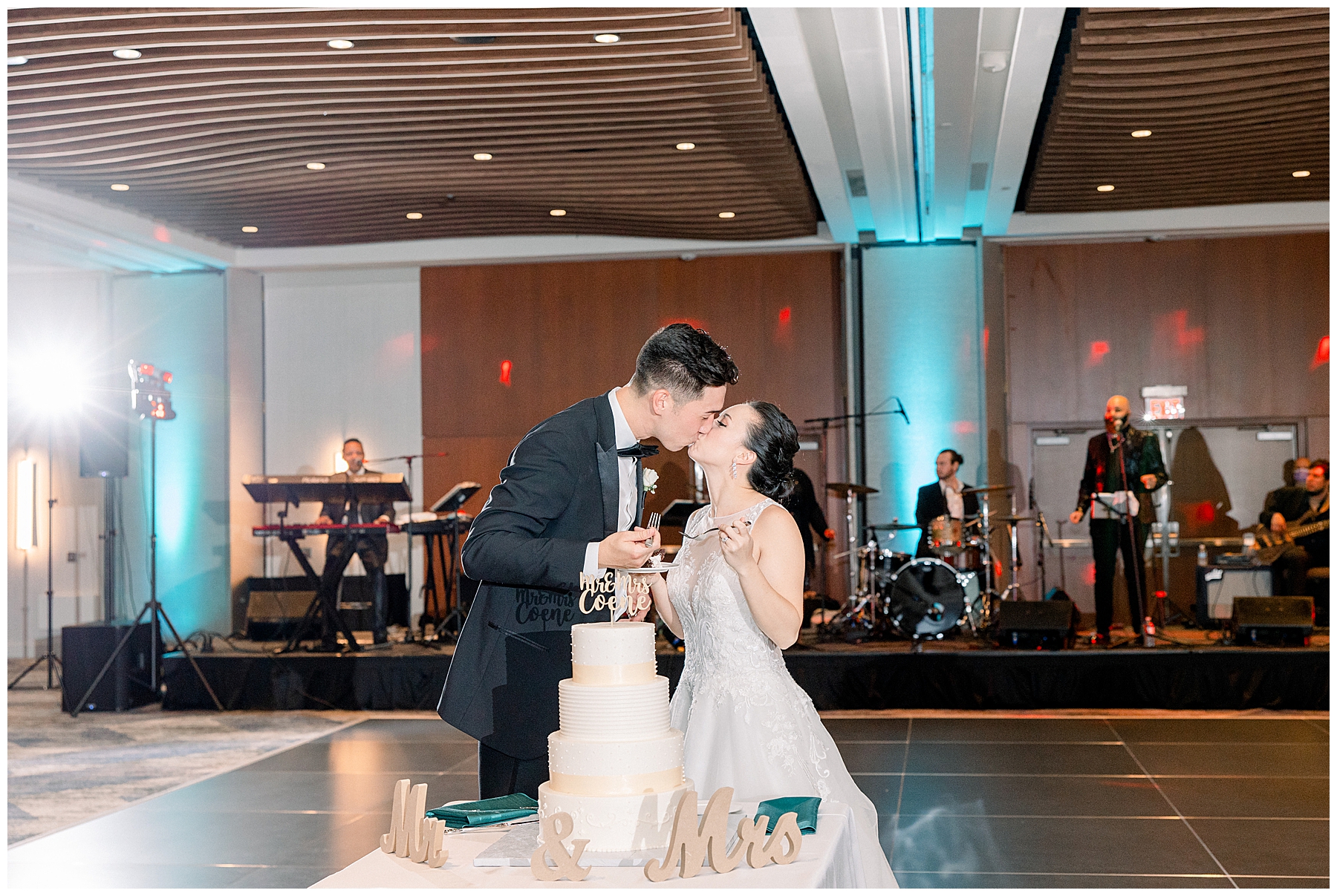 newlyweds kiss after their cake cutting