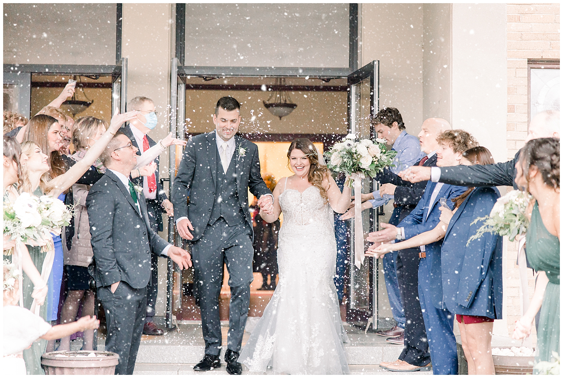 wedding guests throw fake snow at newlyweds