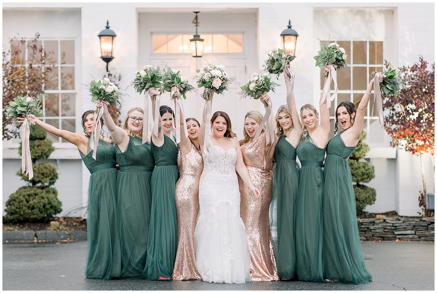 bridesmaids in evergreen dresses and bride hold up wedding bouquets