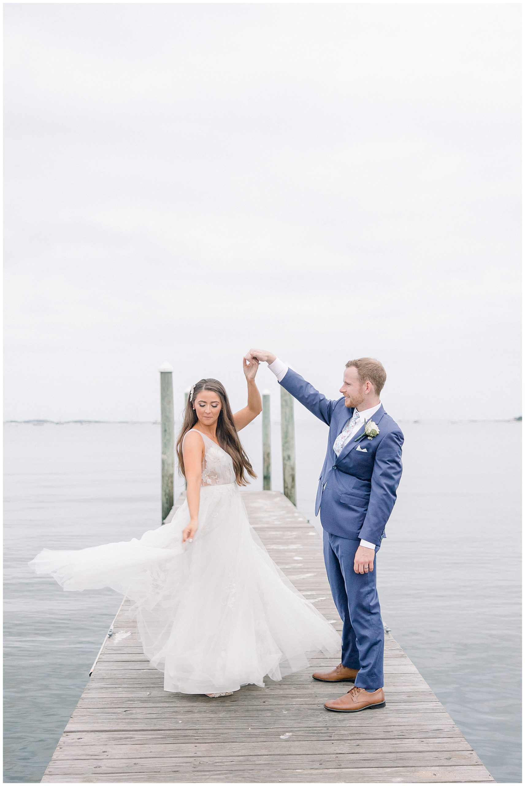 couple on the dock at waterfront wedding venue shining tides
