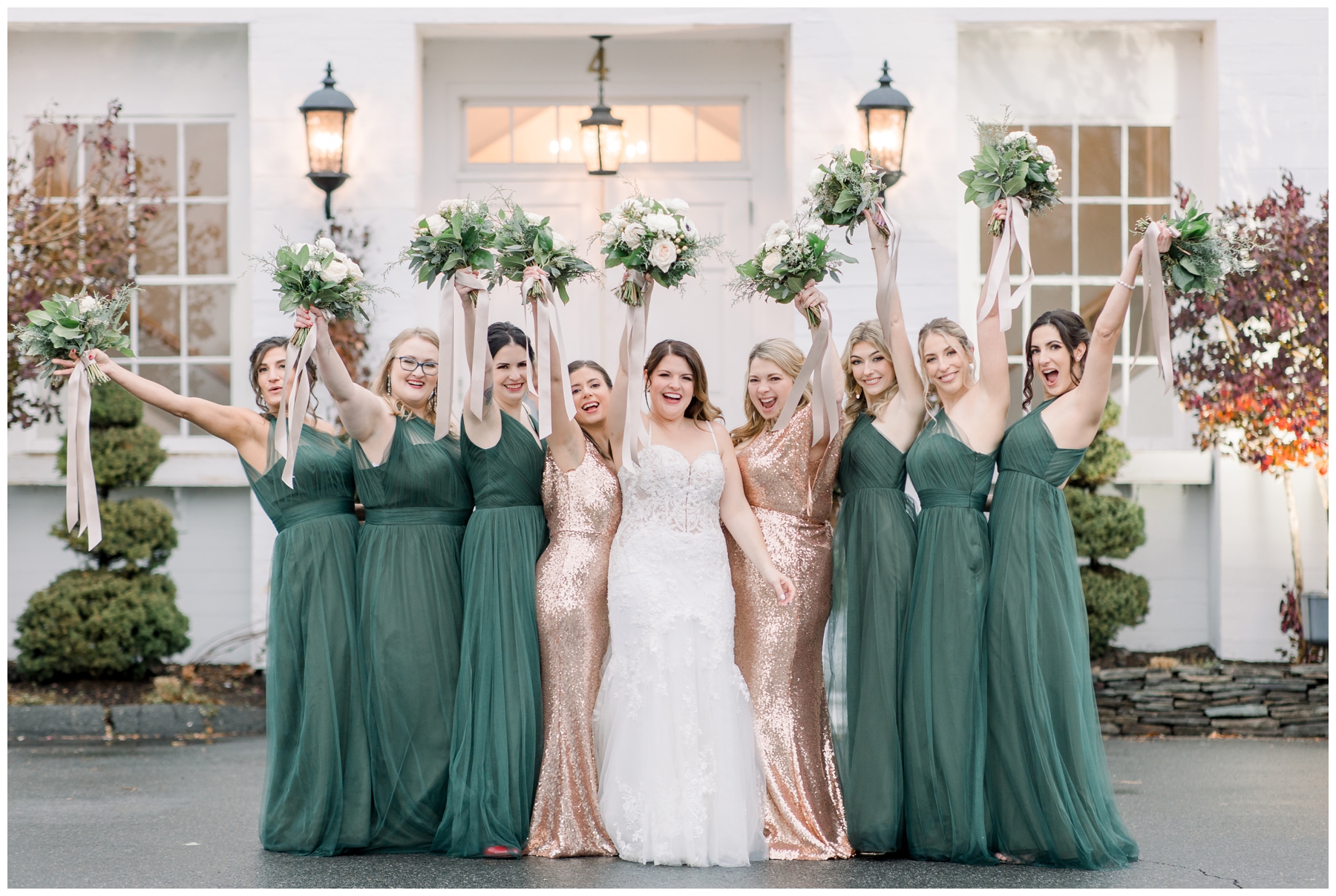 Bridesmaids pose for photo with flowers in air