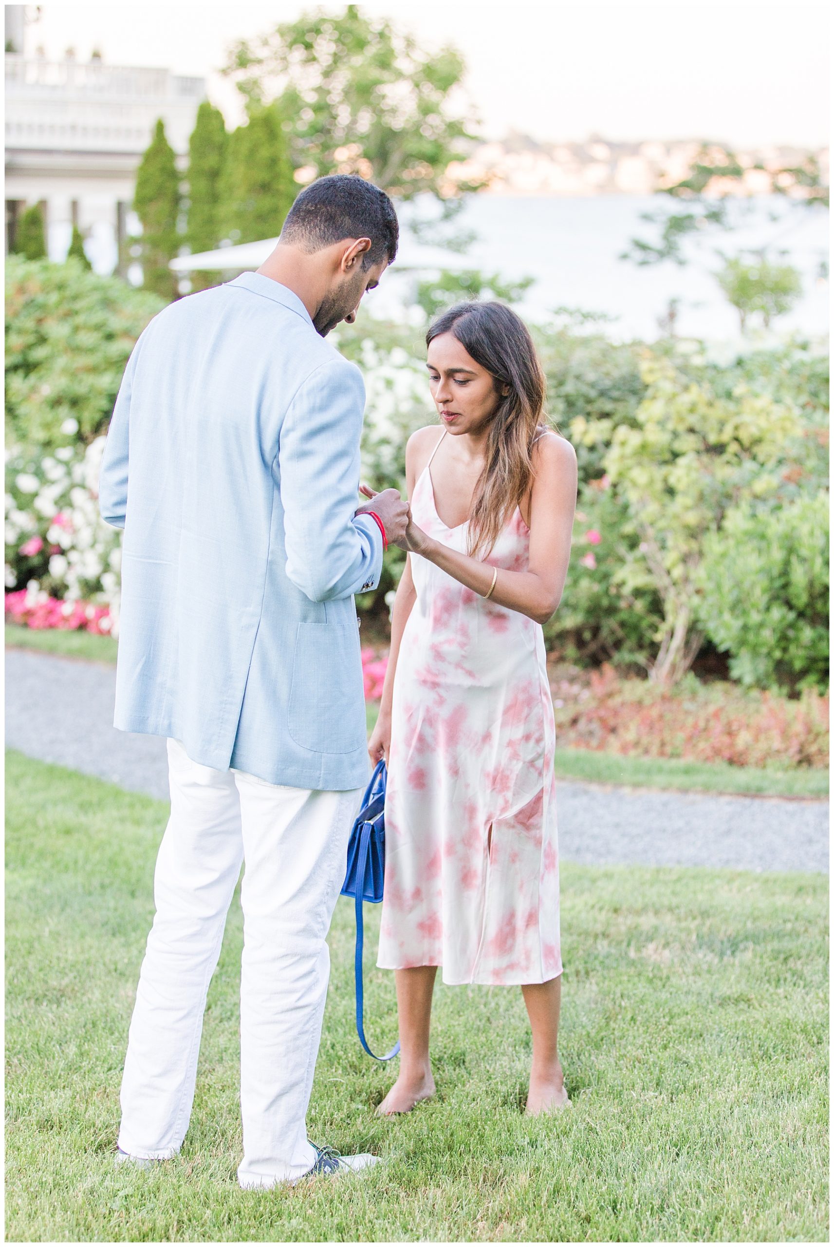 man puts engagement ring on new fiance's finger after surprise proposal at The chanler 