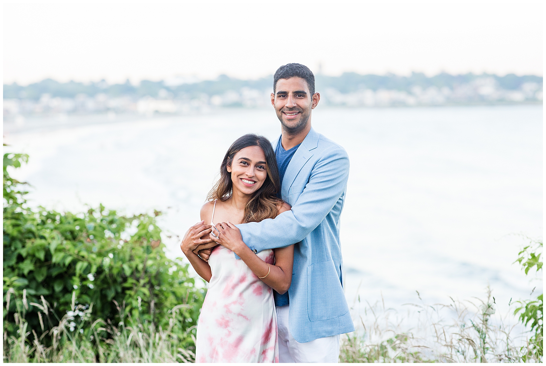 newly engaged couple stand in front of ocean views in Newport