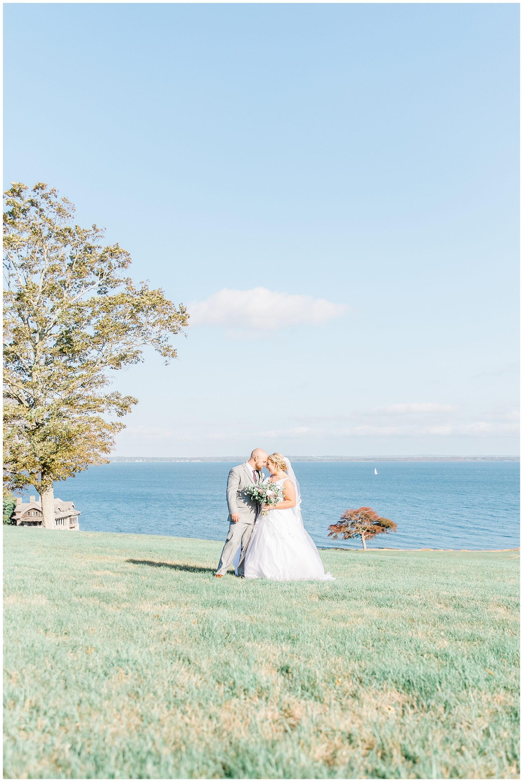 Couple stand on the grounds of Aldrich Mansion overlooking Narragansett Bay in RI 