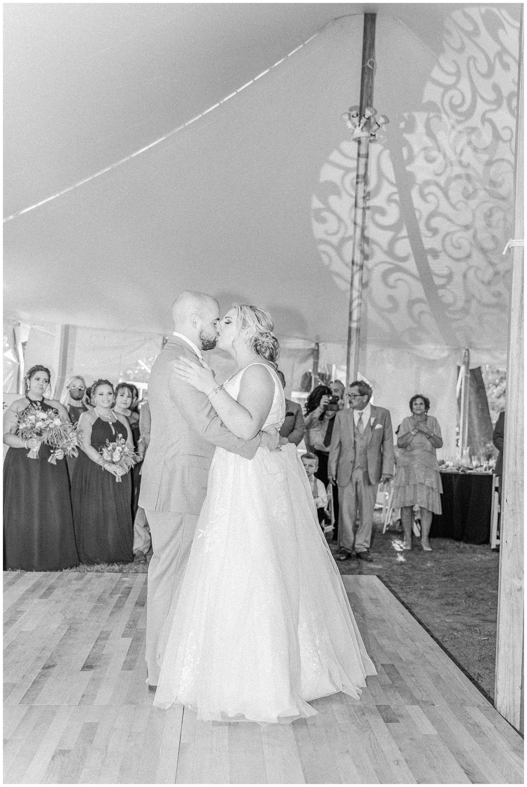 newlyweds kiss on the dance floor at wedding reception