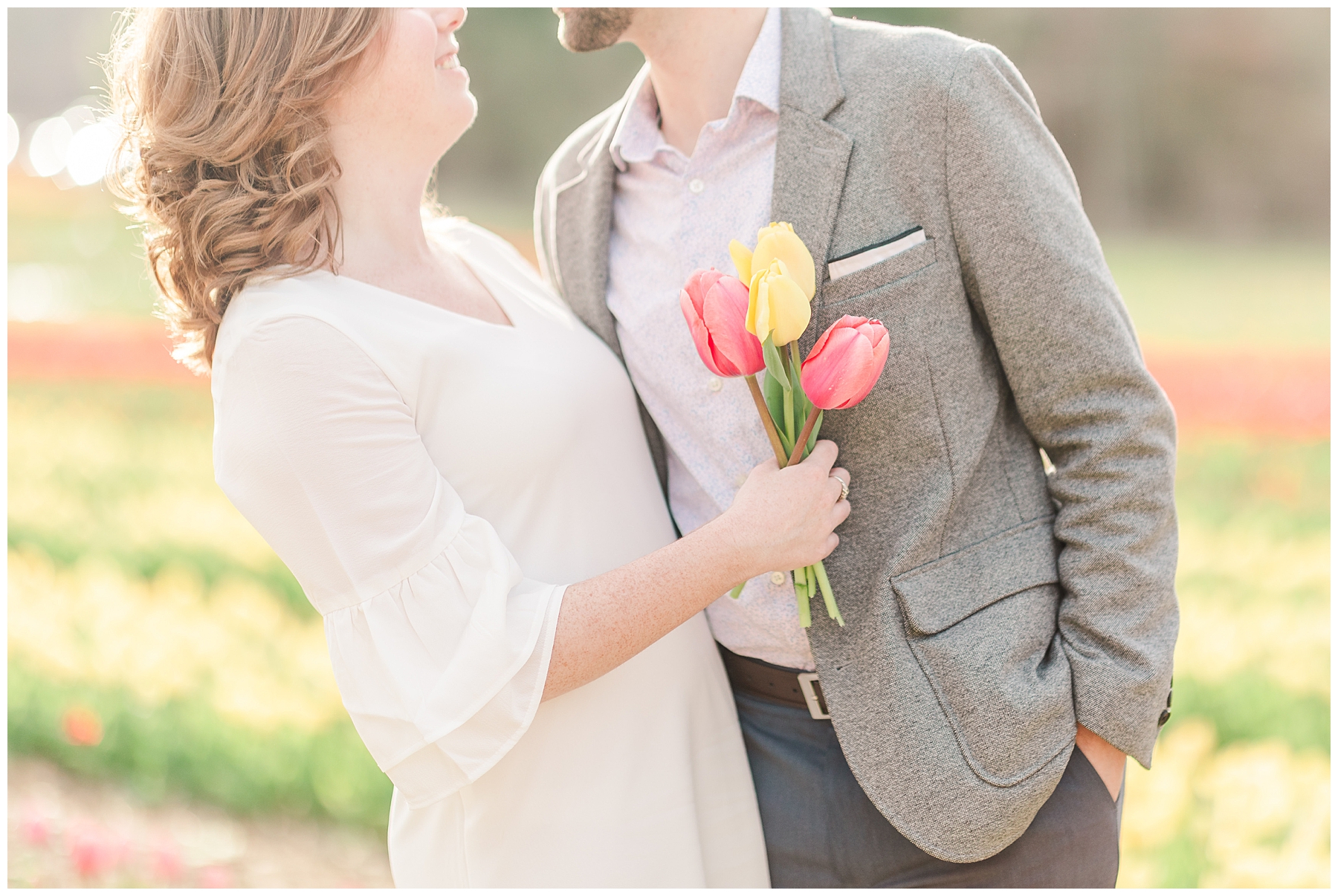 couple during engagement session holding tulips